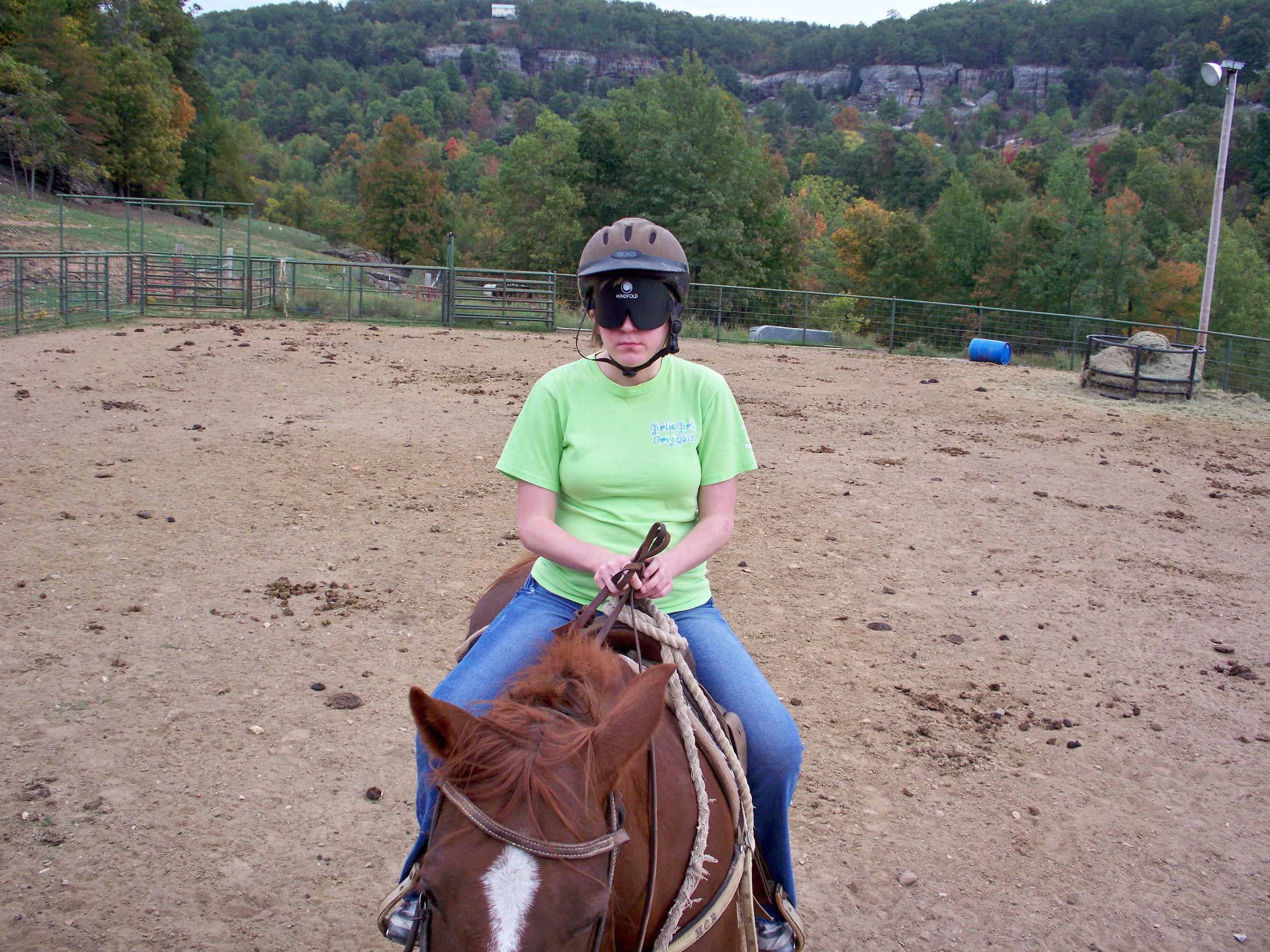 Katie riding her horse in the arena at HCR