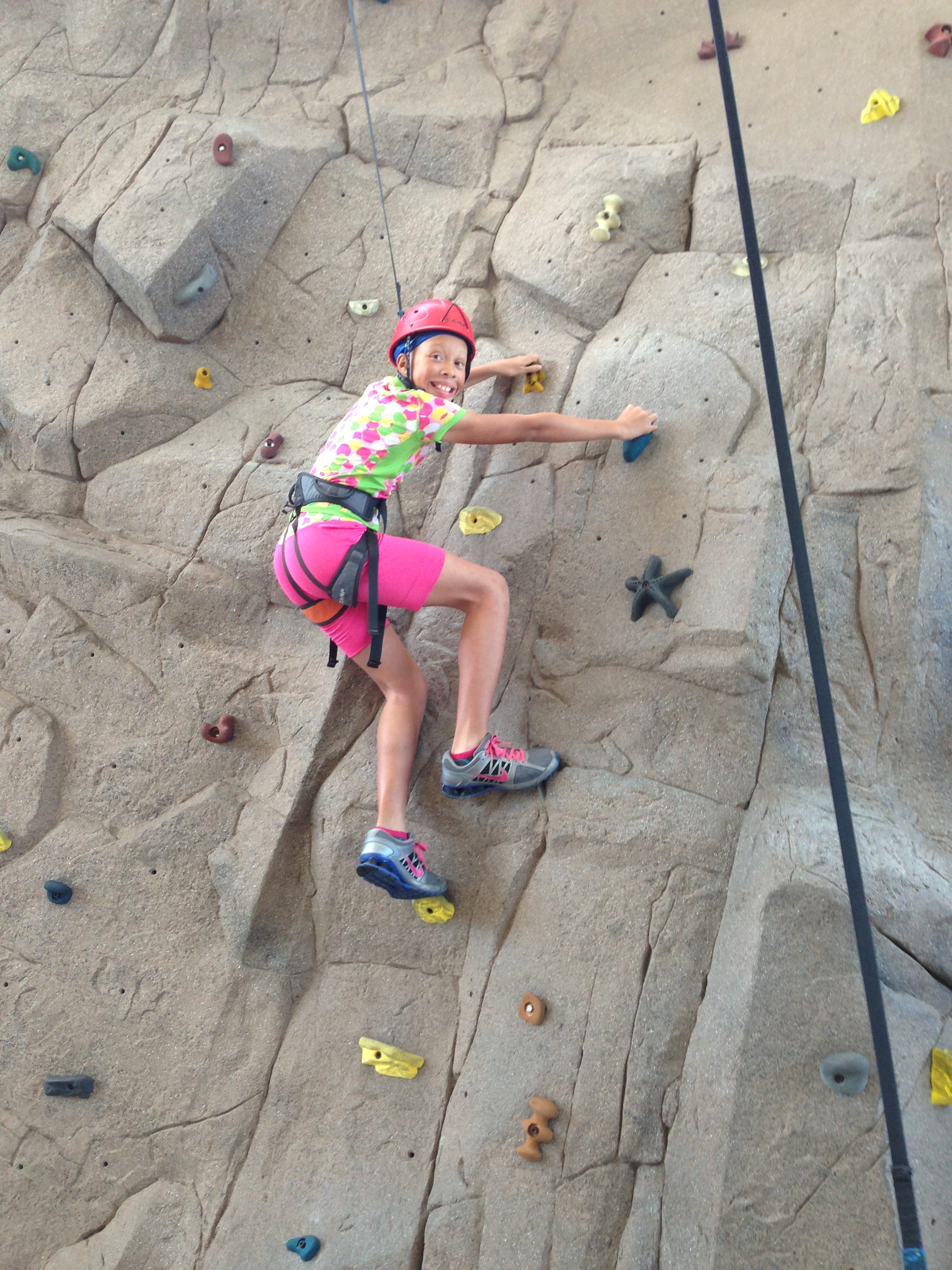 Kiona climbs the rock wall at LATech