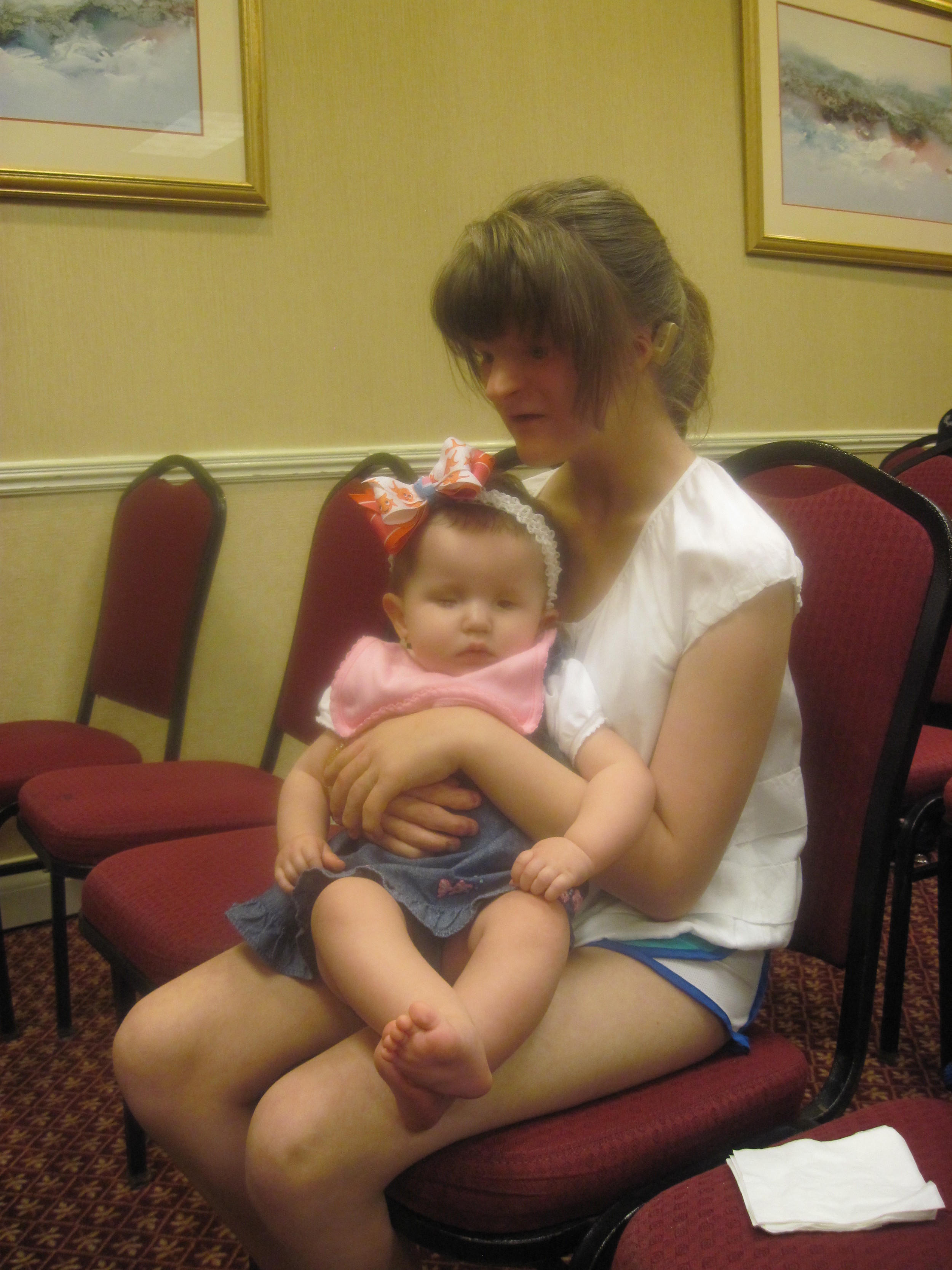 Sophie (in our Infant/Toddler program years ago) holds Addison