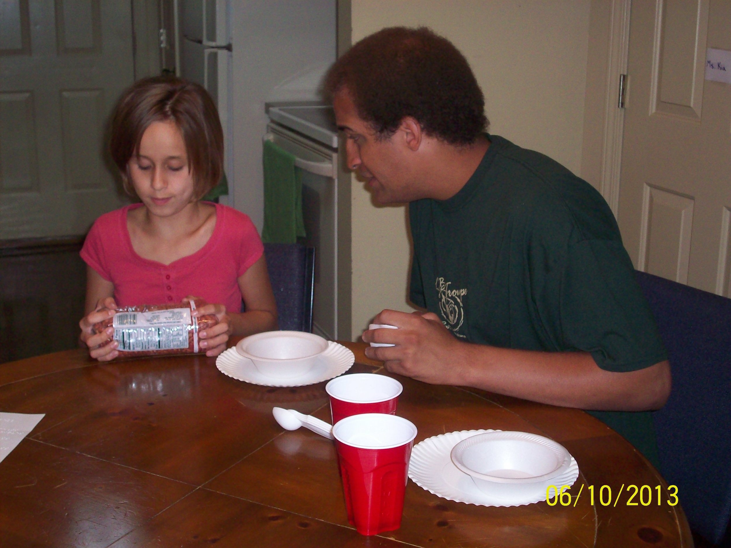 Lindsay prepares to scoop and pour beans