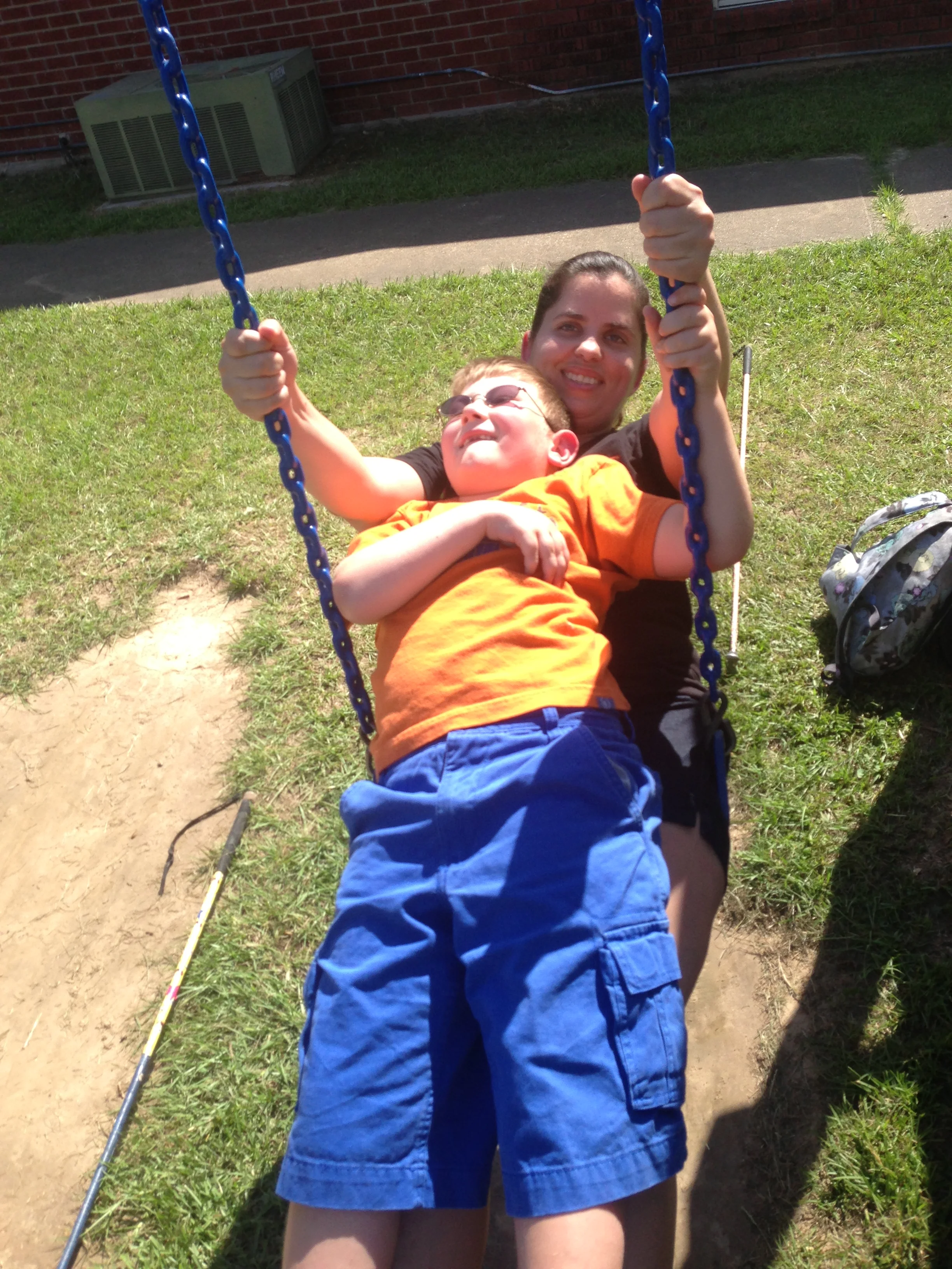 Ms. Danielle swinging with Nicholas