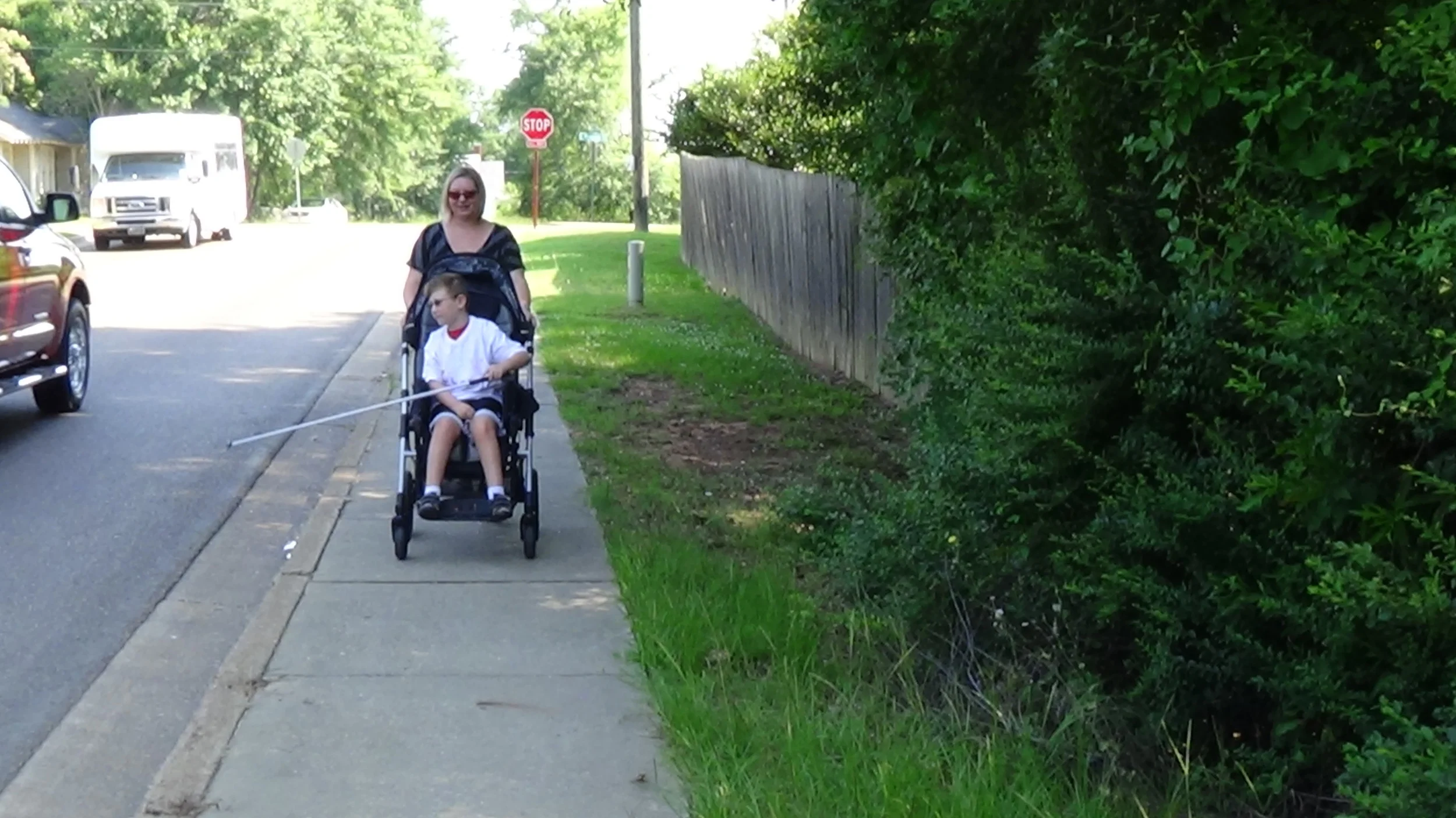 Nicholas shorelines as Ms. Kristen pushes him in his chair