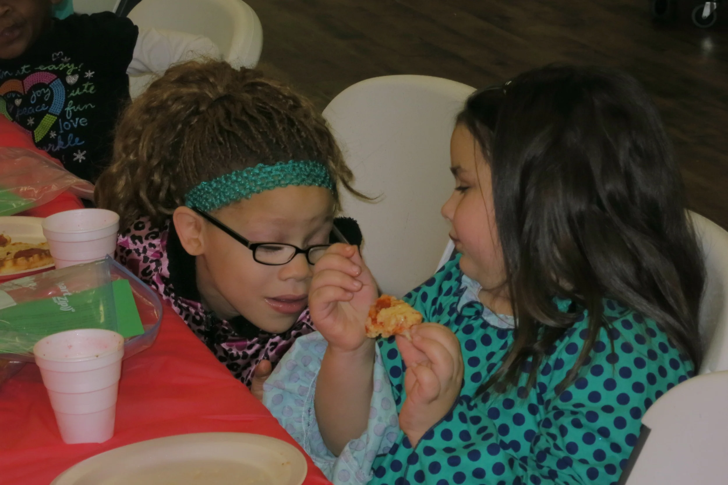 Bri and Maniya talk while eating lunch
