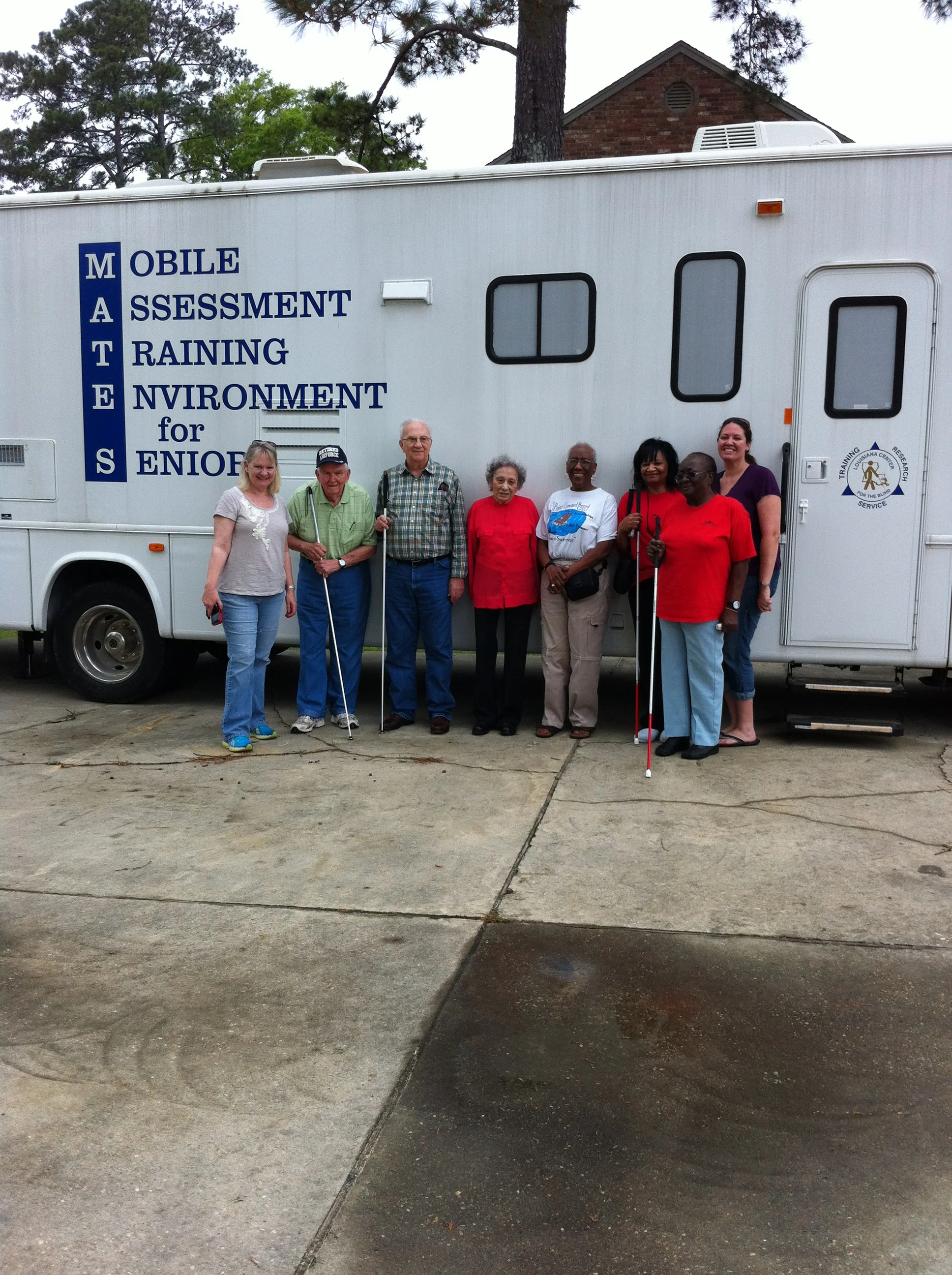 Seniors standing in front of the MATES RV