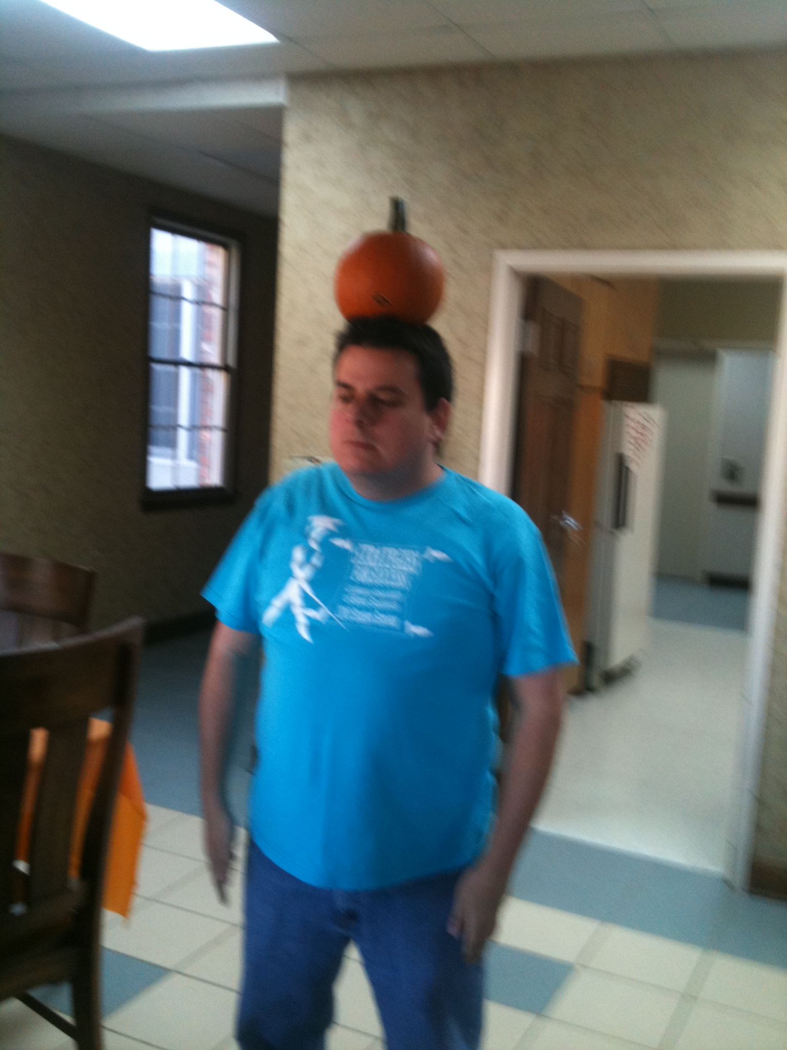 Mr. G balances a pumpkin on his head at  a fall-themed Saturday Club