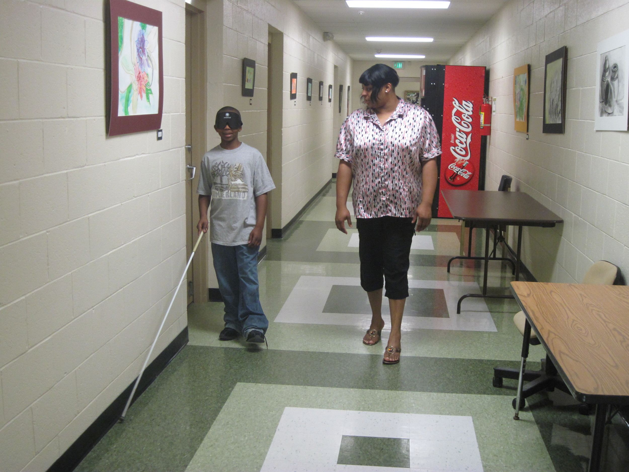 Terrell shows off his cane skills for his mom