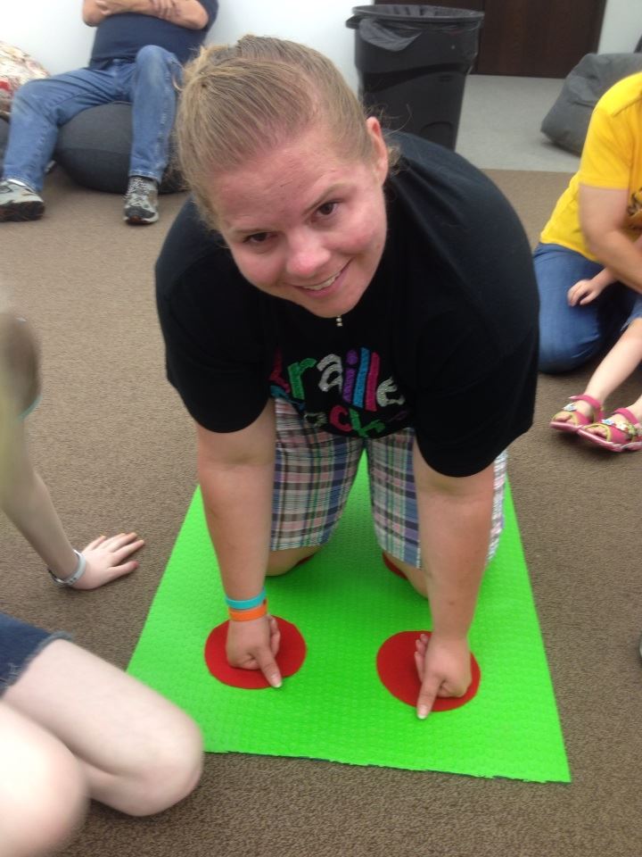 Natalie Shaheen make a for sign on the braille twister board!