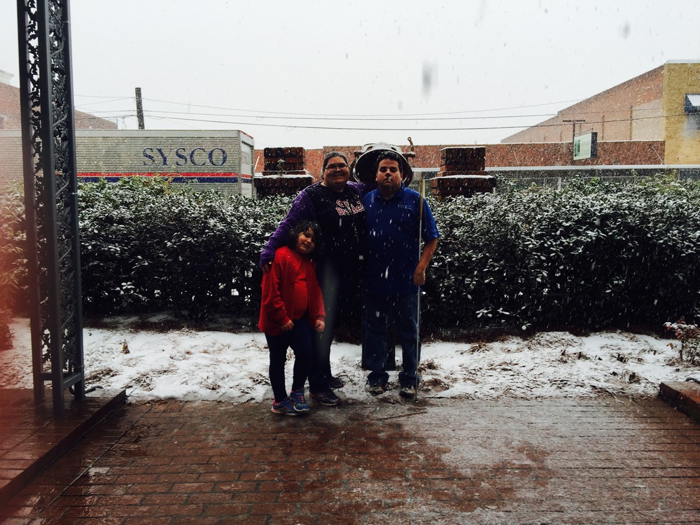 Eric, Kystal, and Bri pose for a picture in the snow