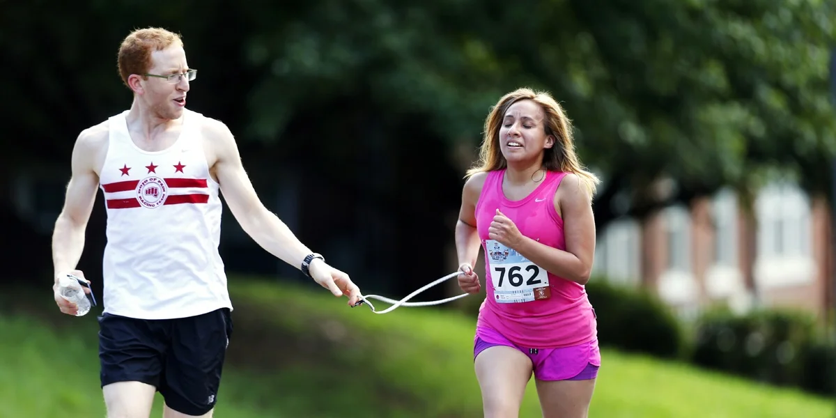 Evelyn and her trainer running in the Marathon.