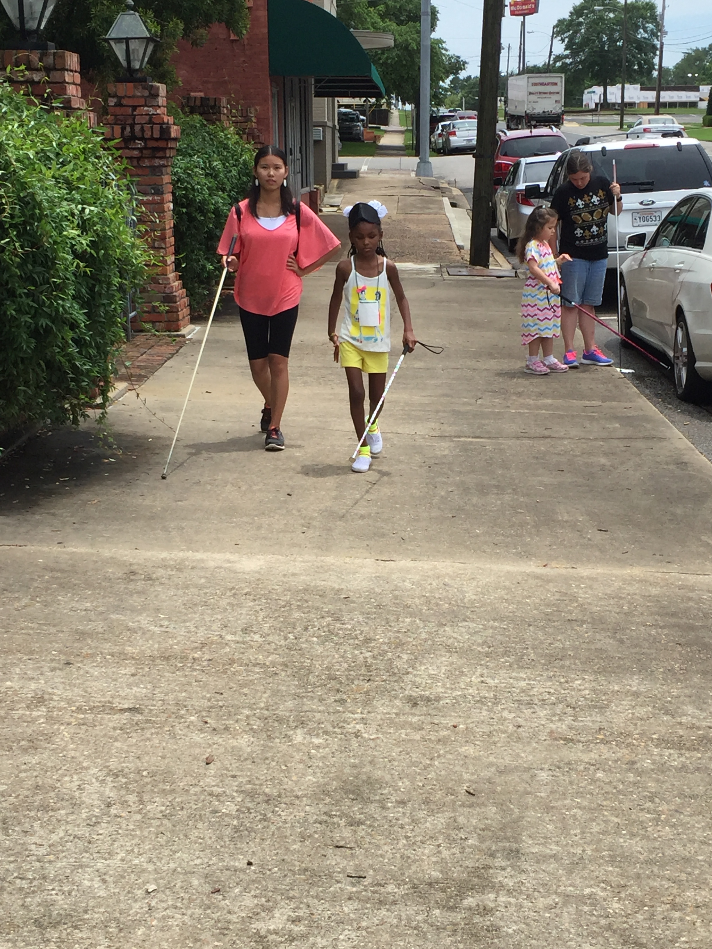 Jayla and Ms. Michell use their long white canes on travel