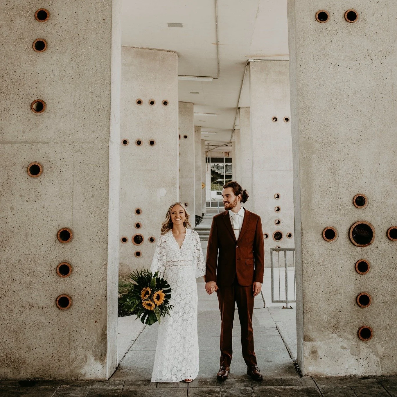 They matched the space without even trying. Browns, greens, and whites against the  industrial look of Hamilton City Hall. Super underrated for wedding photos.