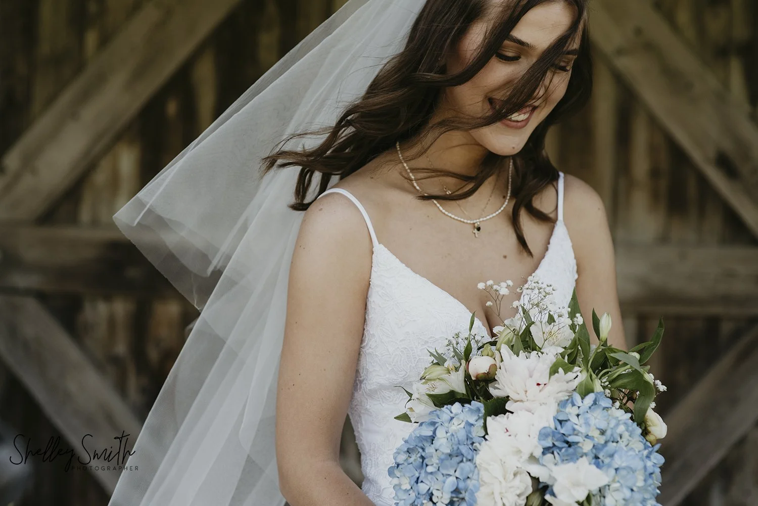 Close-up of bride with wooden textures at Windecker Woods wedding
