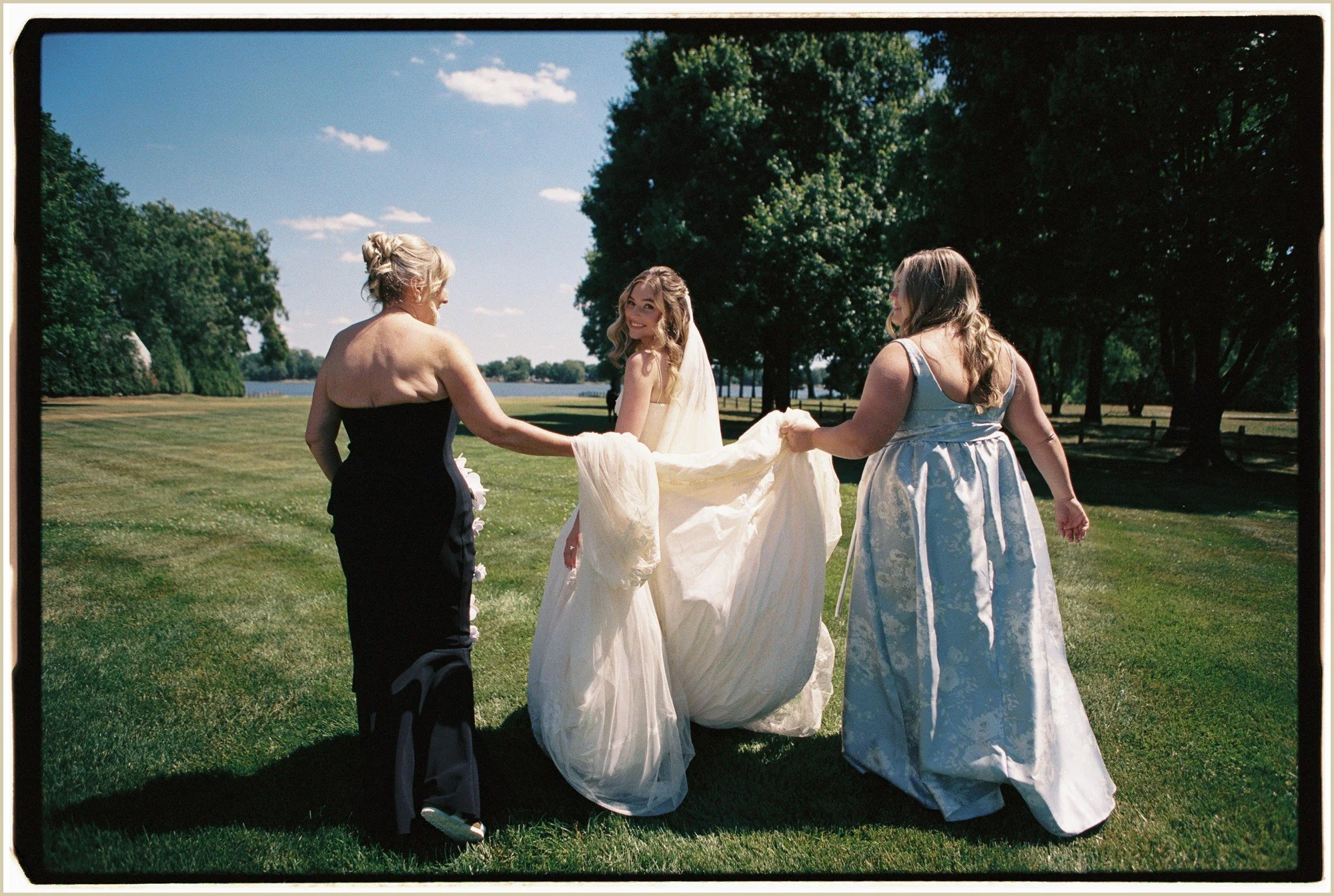 candid film photo of mother helping bride with dress before first look