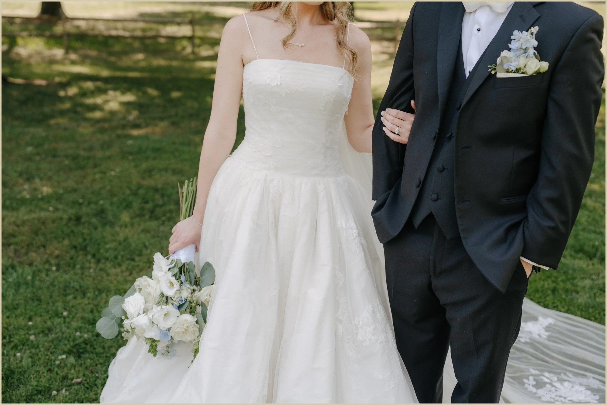 close up of bride holding onto grooms arm