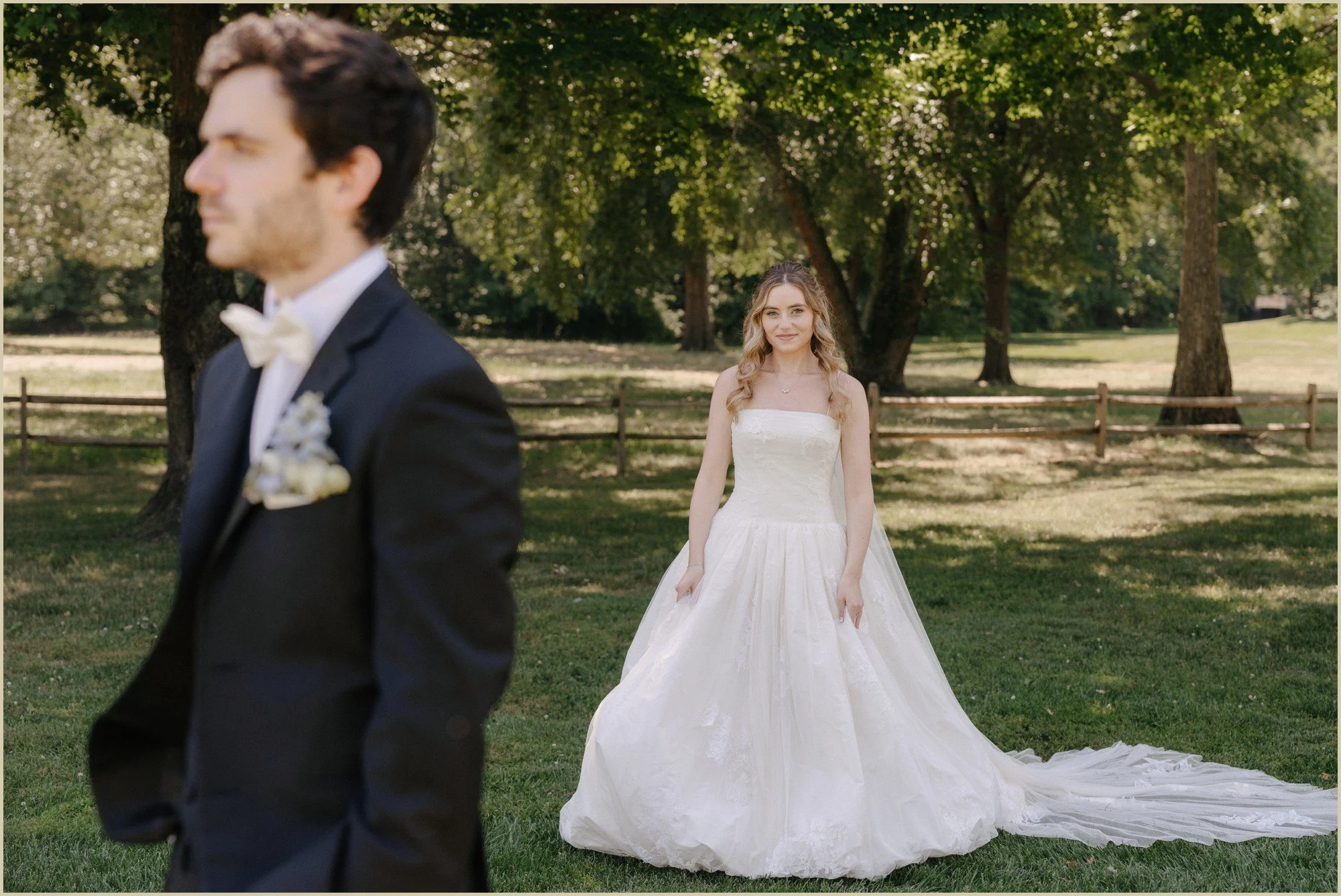 editorial pose groom in foreground bride in focus in background