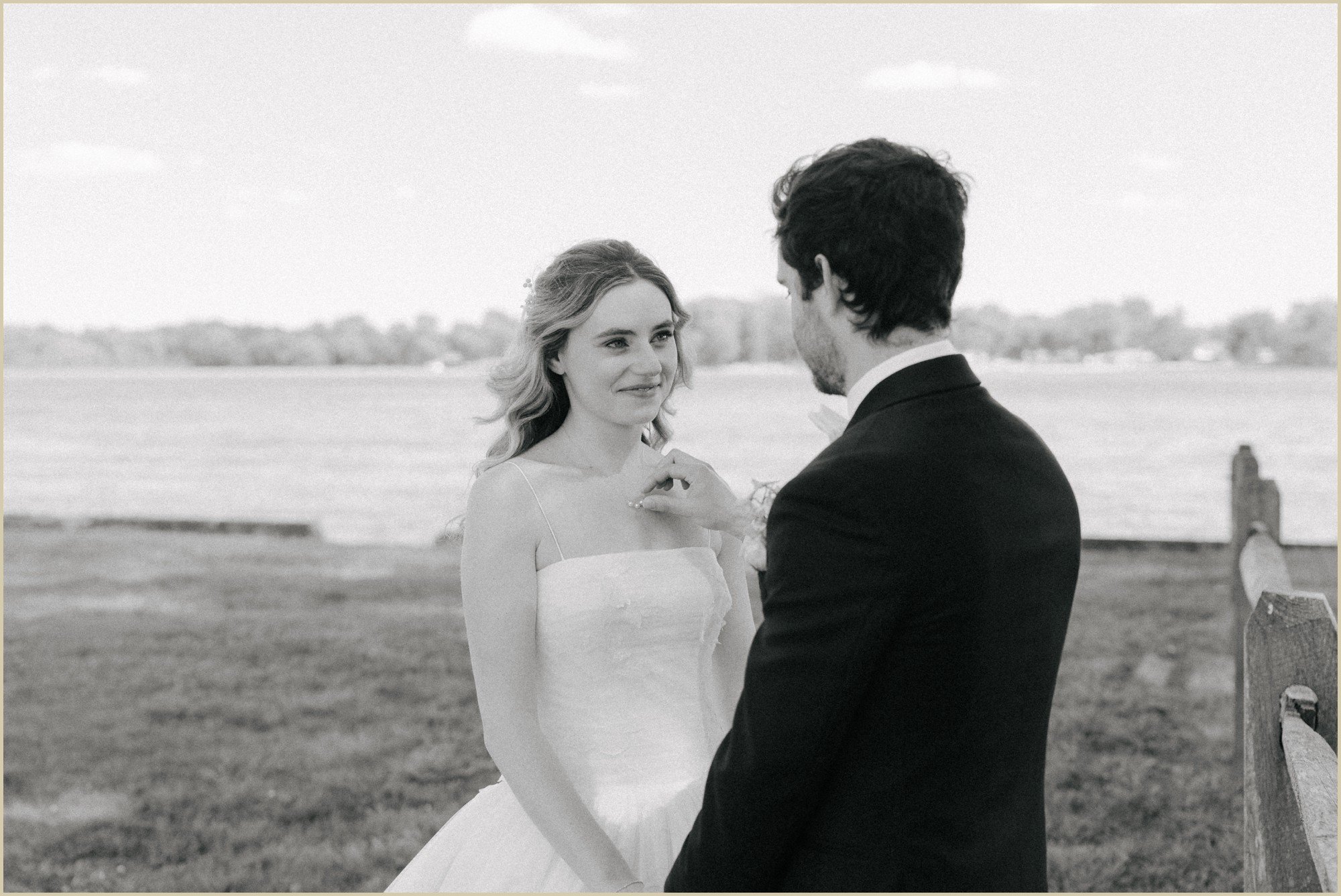 groom fixing brides necklace