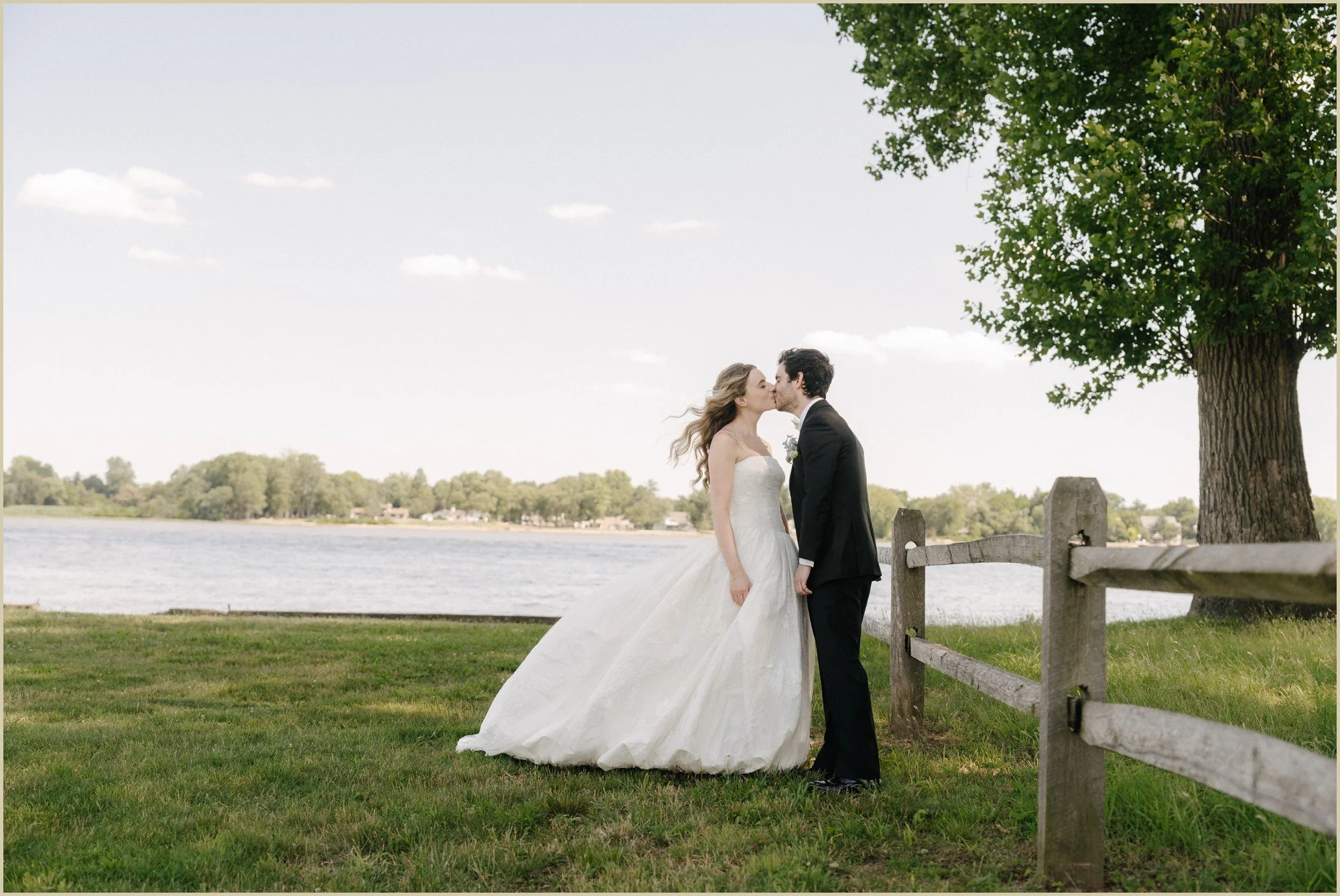 bride and groom kissing on the waterfront at pen ryn estate