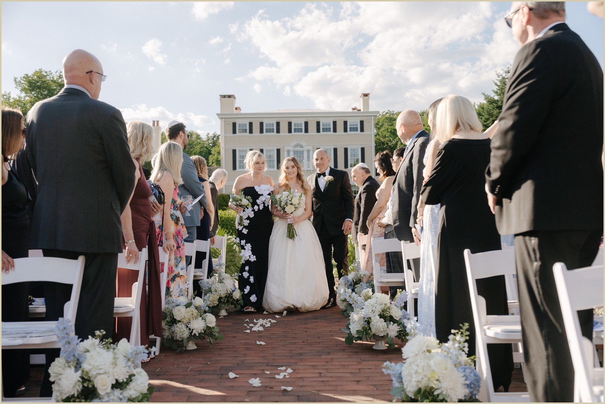 bride walking down the aisle with both parents