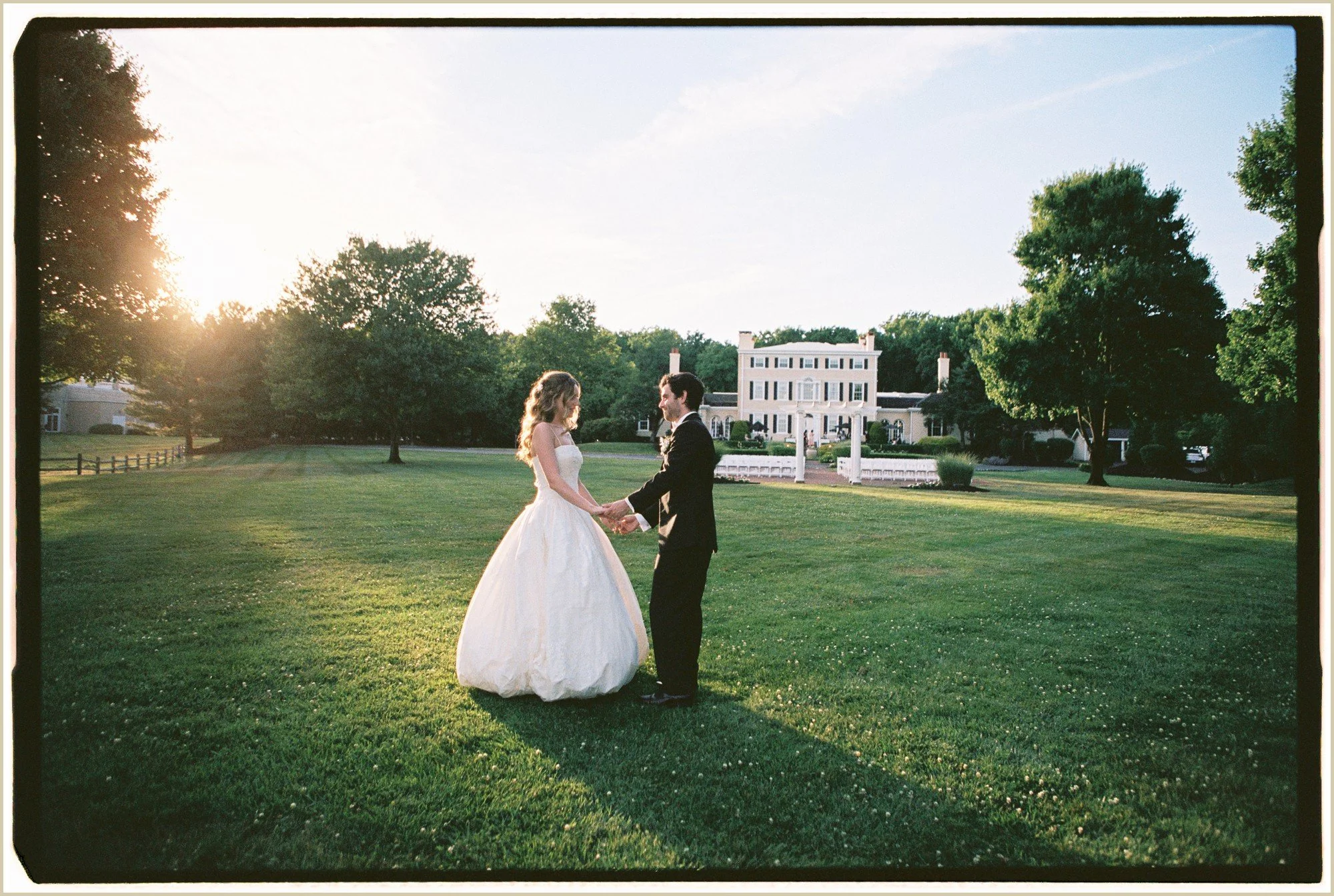 golden hour film wedding photos of bride and groom dancing in lawn outside pen ryn