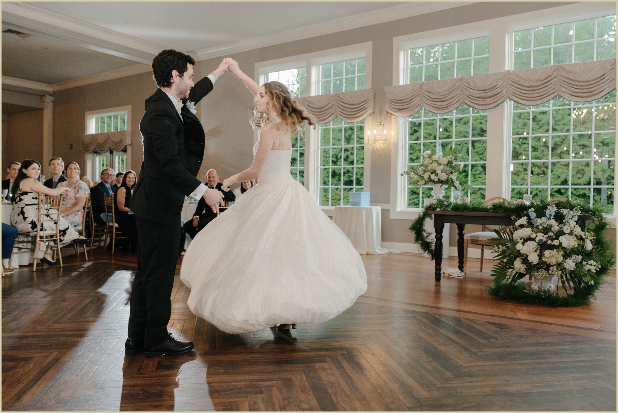 ben spinning hannah on the dance floor during their first dance