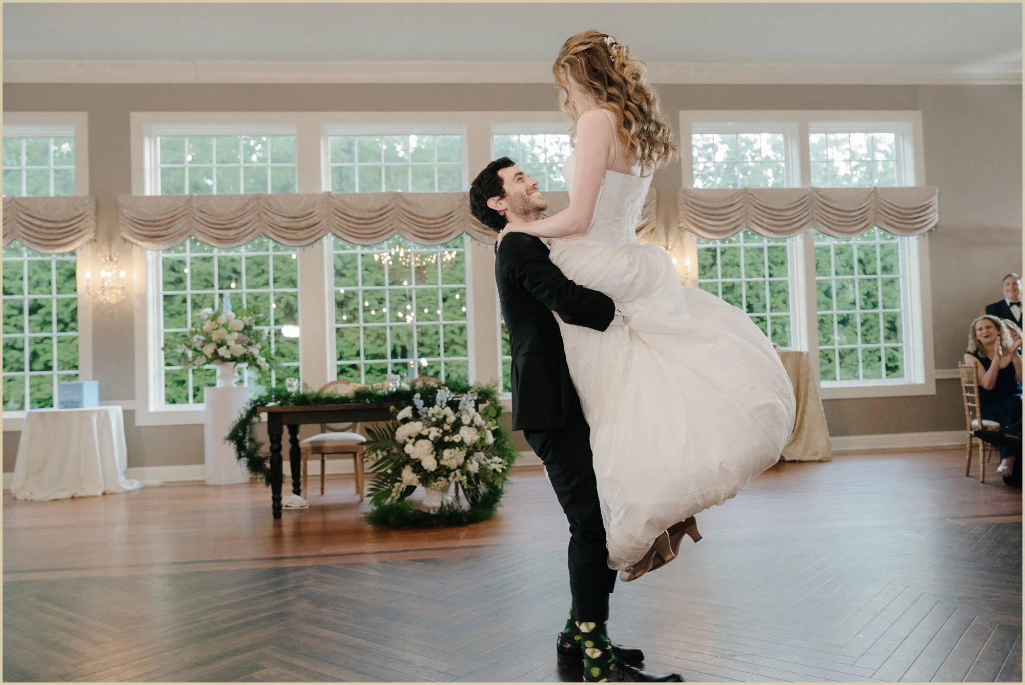 groom lifting bride during their first dance