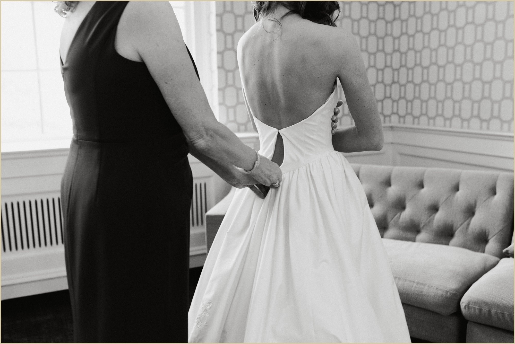 mother of the bride zipping up brides wedding dress