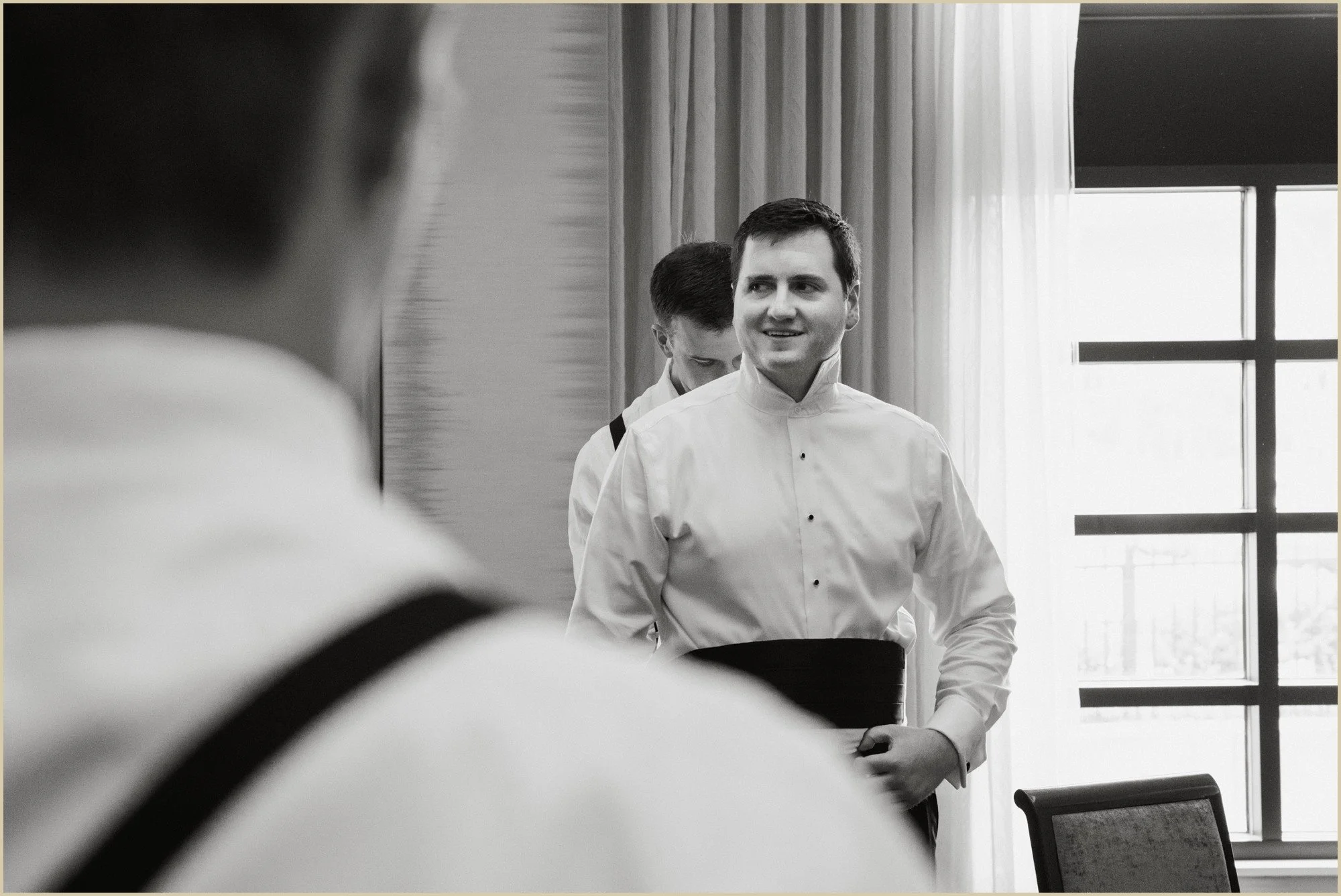 candid of groom getting ready