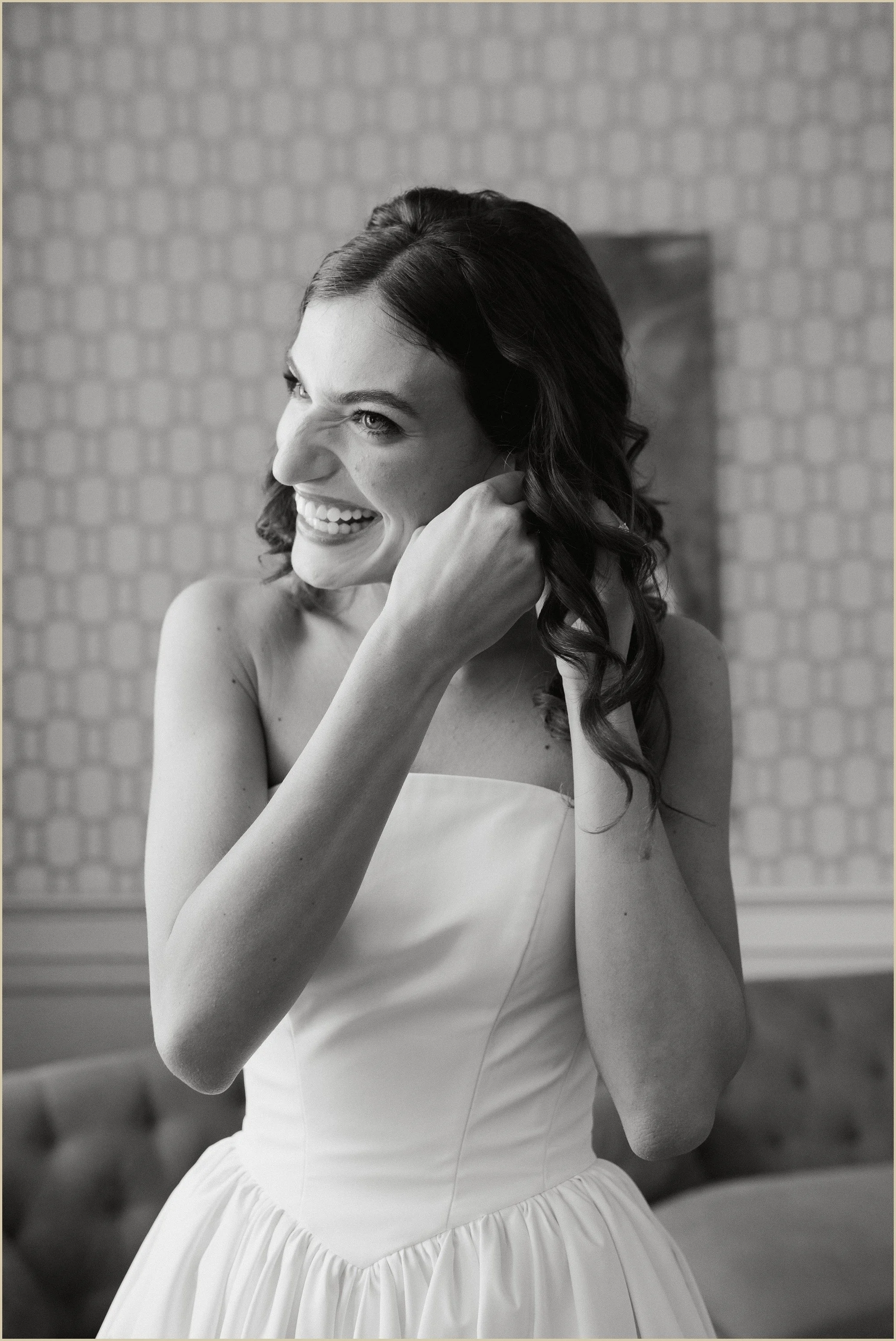 bride laughing and putting her earring in