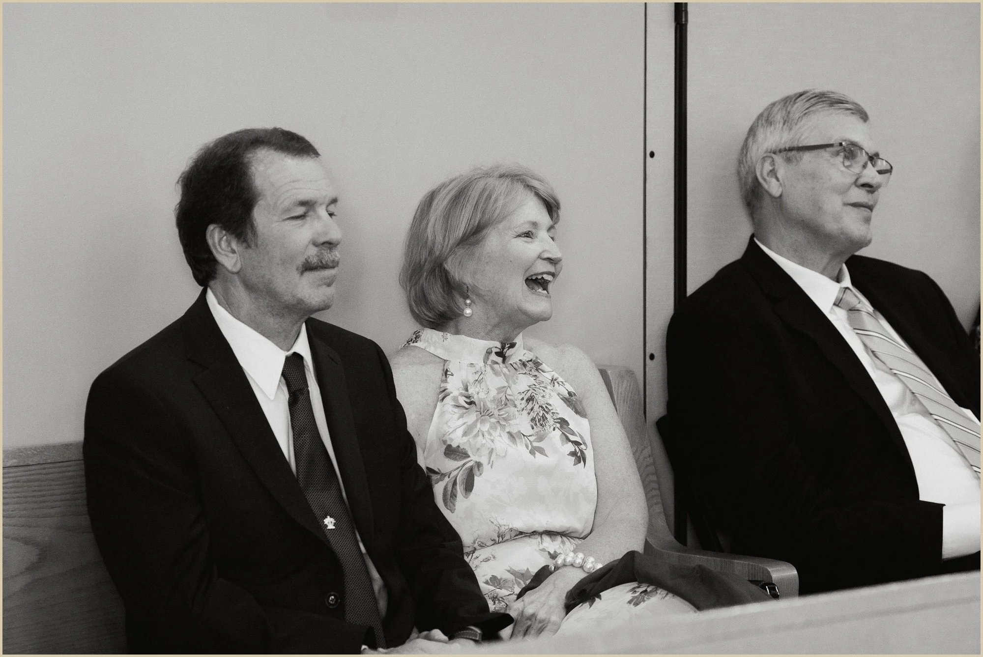 candid documentary style candid of wedding guests laughing