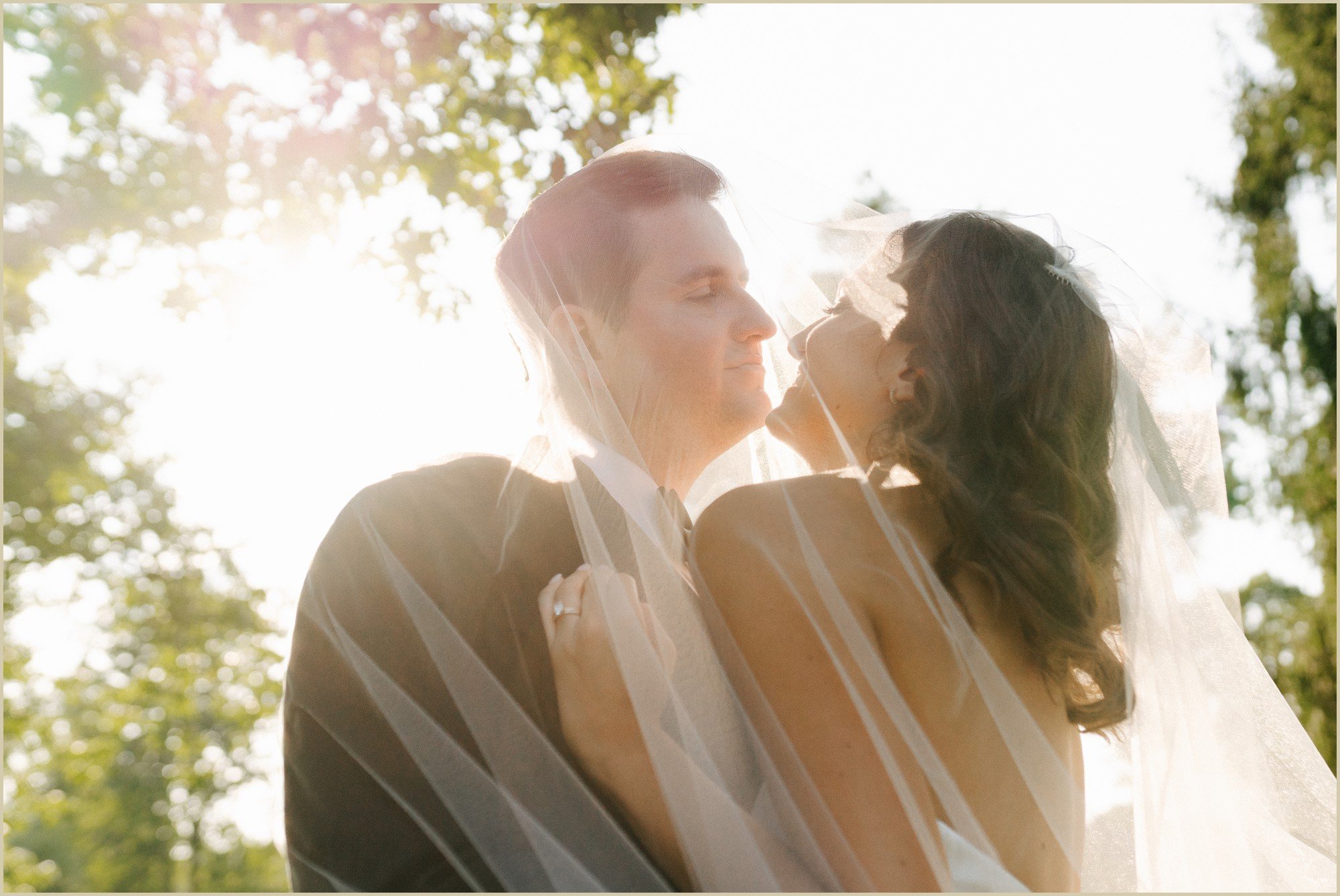 glowy golden light and bride and groom under the veil