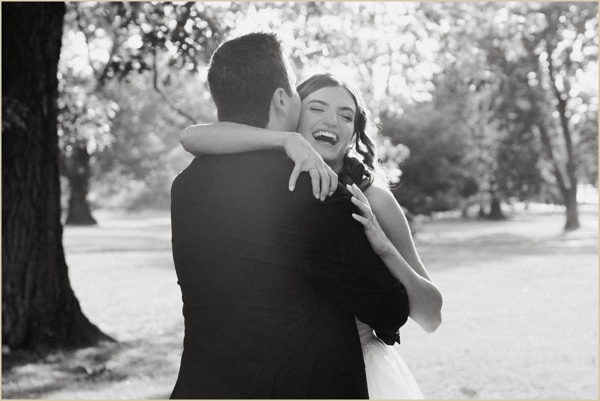 joyful candid of bride hugging and laughing