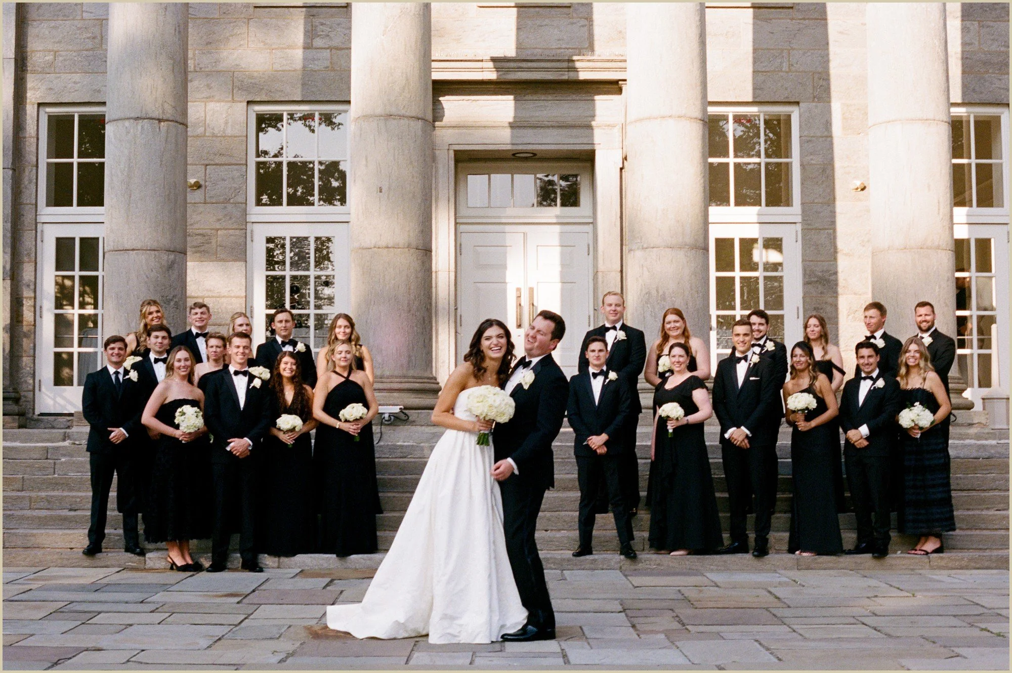 film photograph of a large wedding party all in black