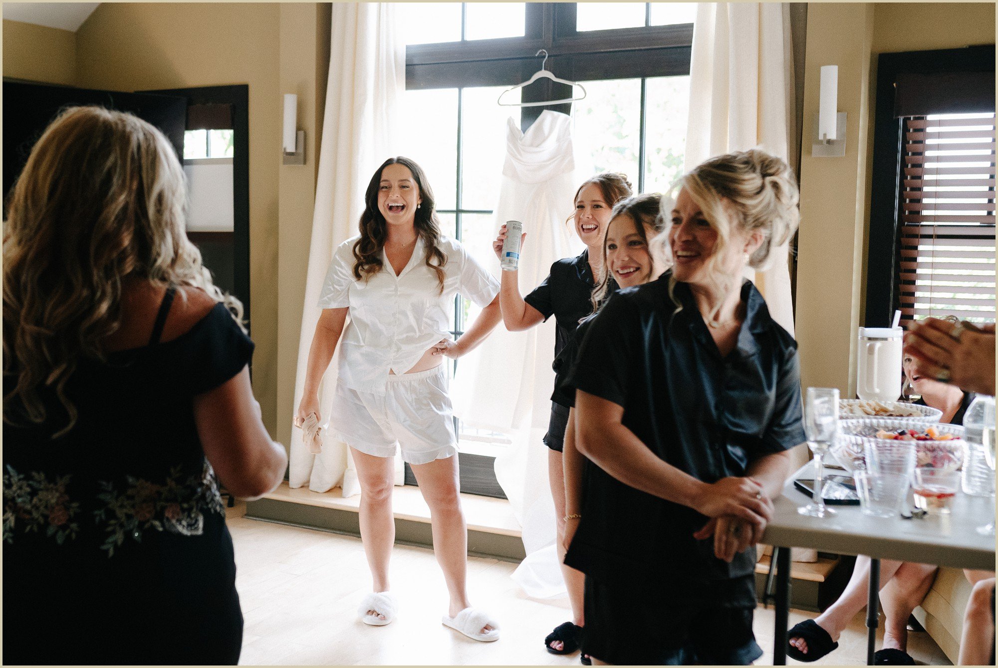 bride laughing with friends during getting ready