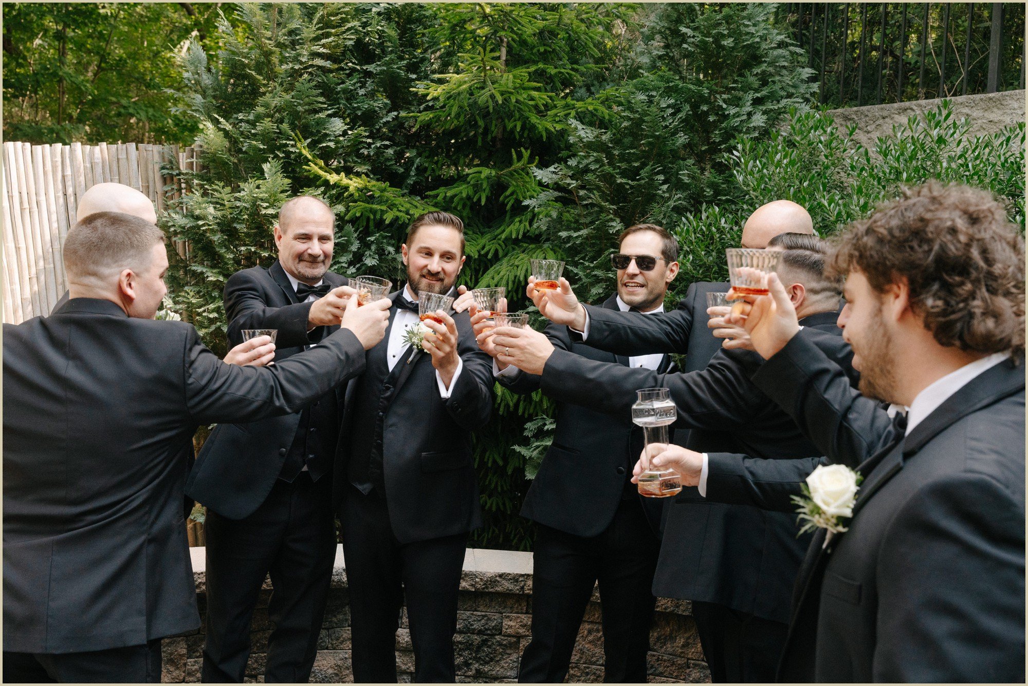 groom and groomsmen toasting before first look