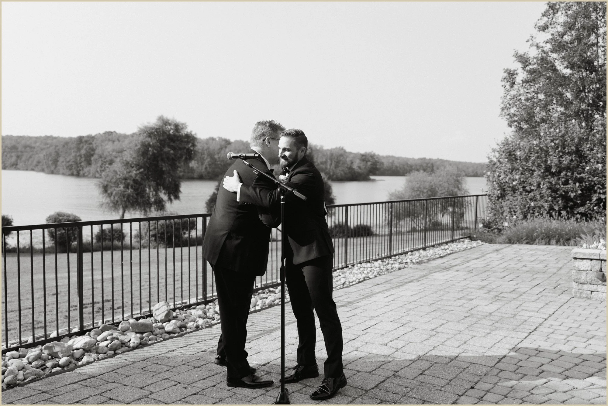 groom hugging officiant after walking down the aisle
