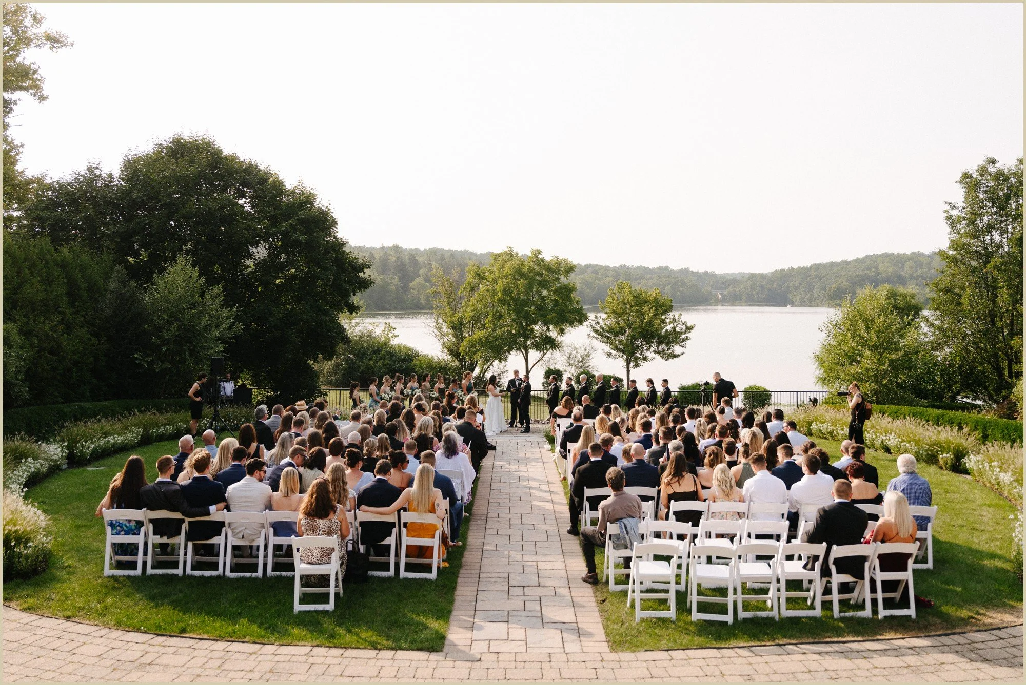 wide photo of wedding ceremony at the lake house inn