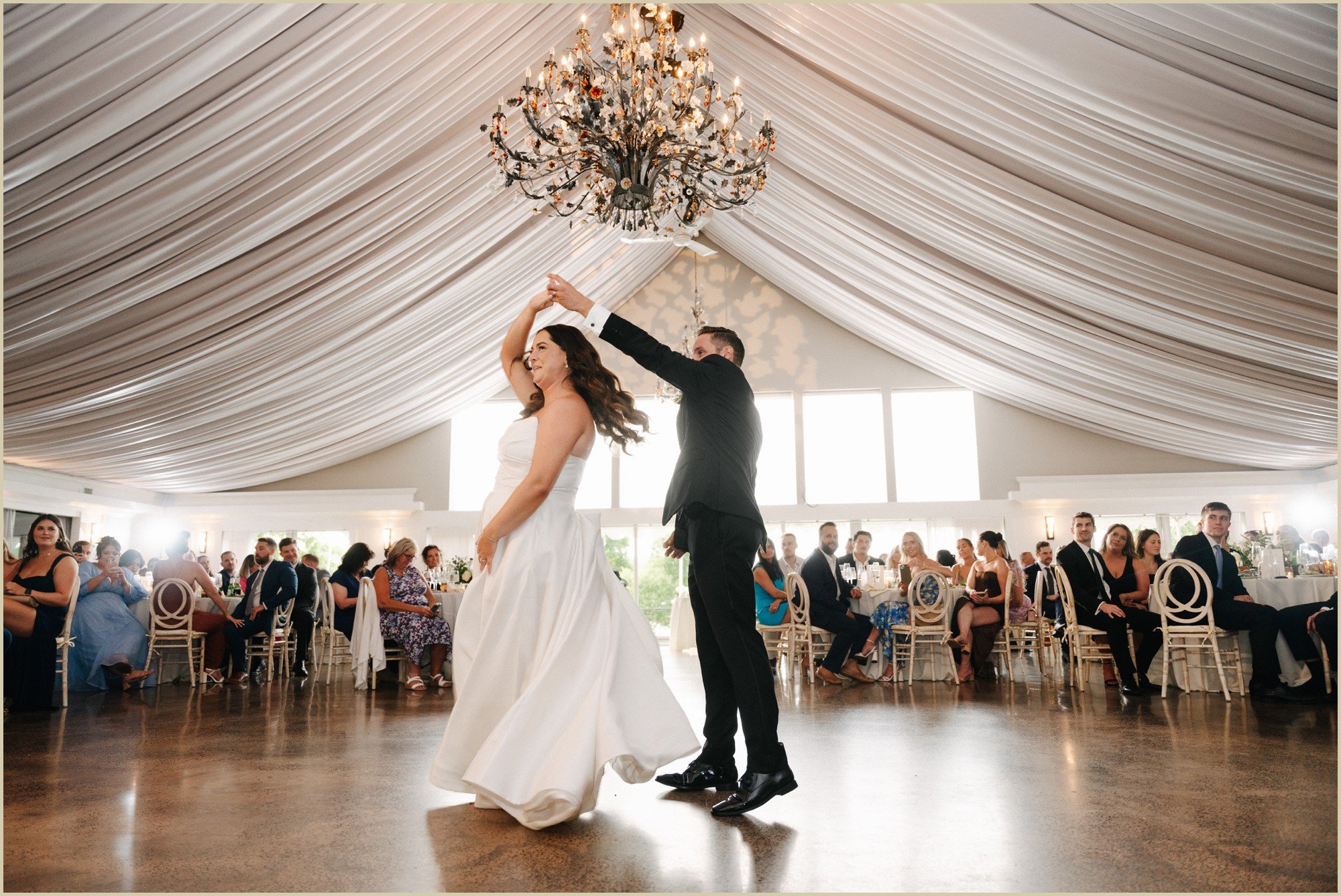 groom spinning bride during first dance