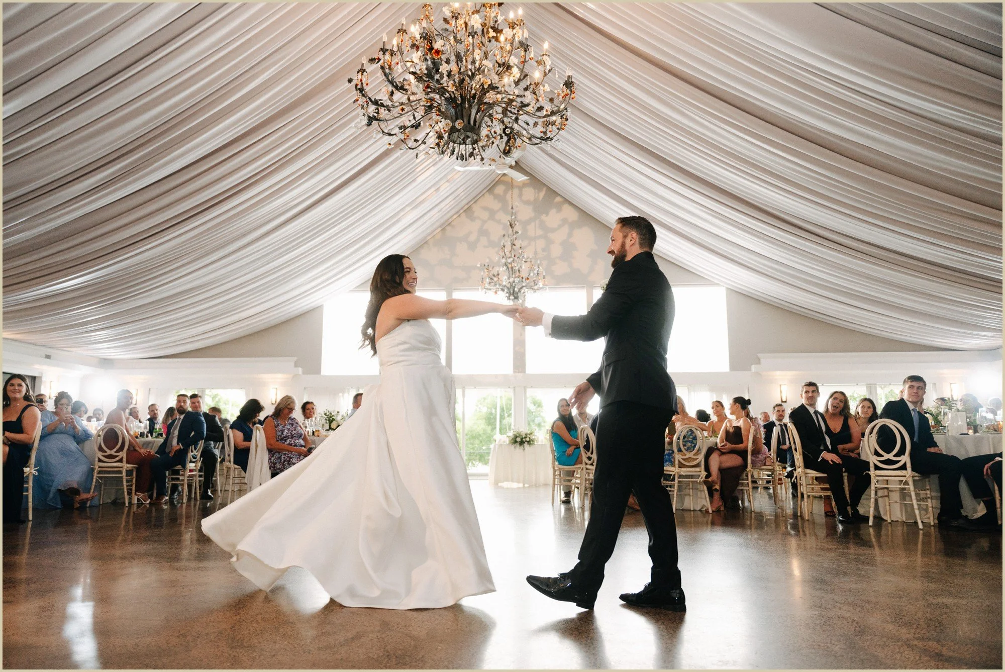 first dance under dramatic drapes and chandelier chandel