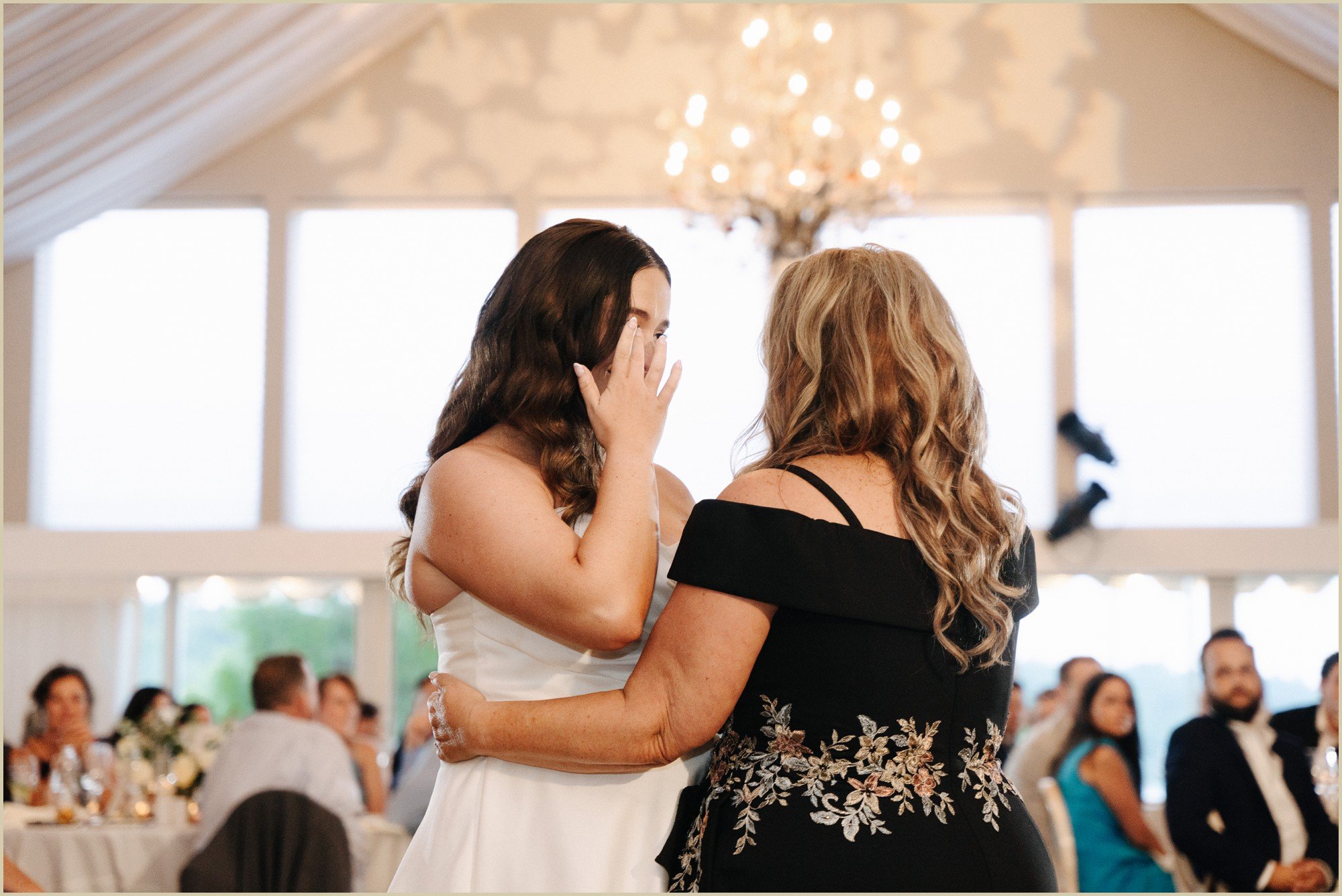 bride emotional while dancing with mother