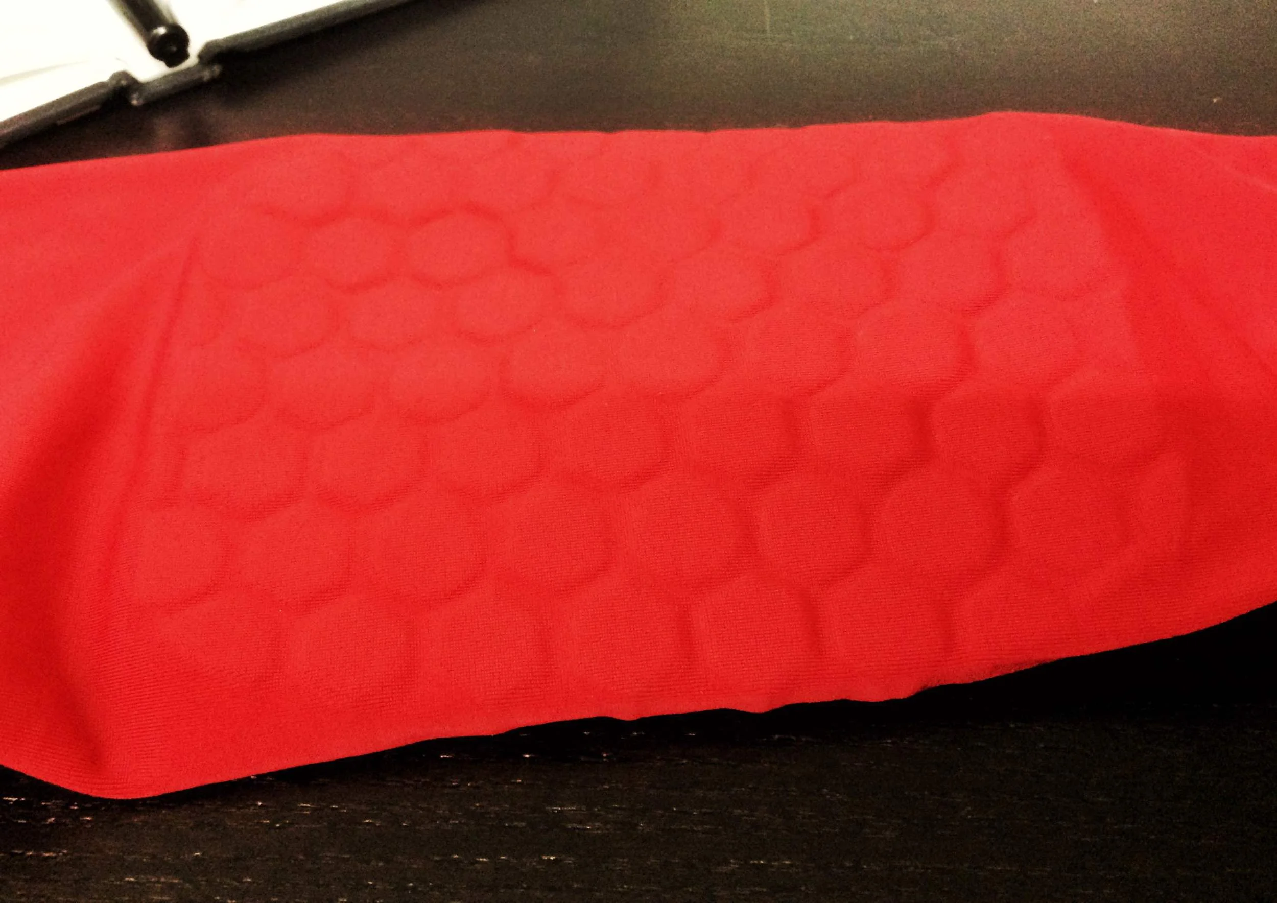 A basketball shooting sleeve with thick pieces of encapsulated Ariaprene.