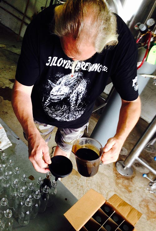 John filling bottles of our collabo hot sauce. 