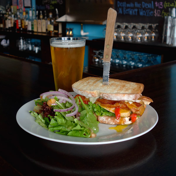 The Mother Clucker: Chicken breast, bacon, roasted red peppers, garlic, lettuce, tomato, egg-over-easy, herbed aioli. Served on toasted potato bread. $11