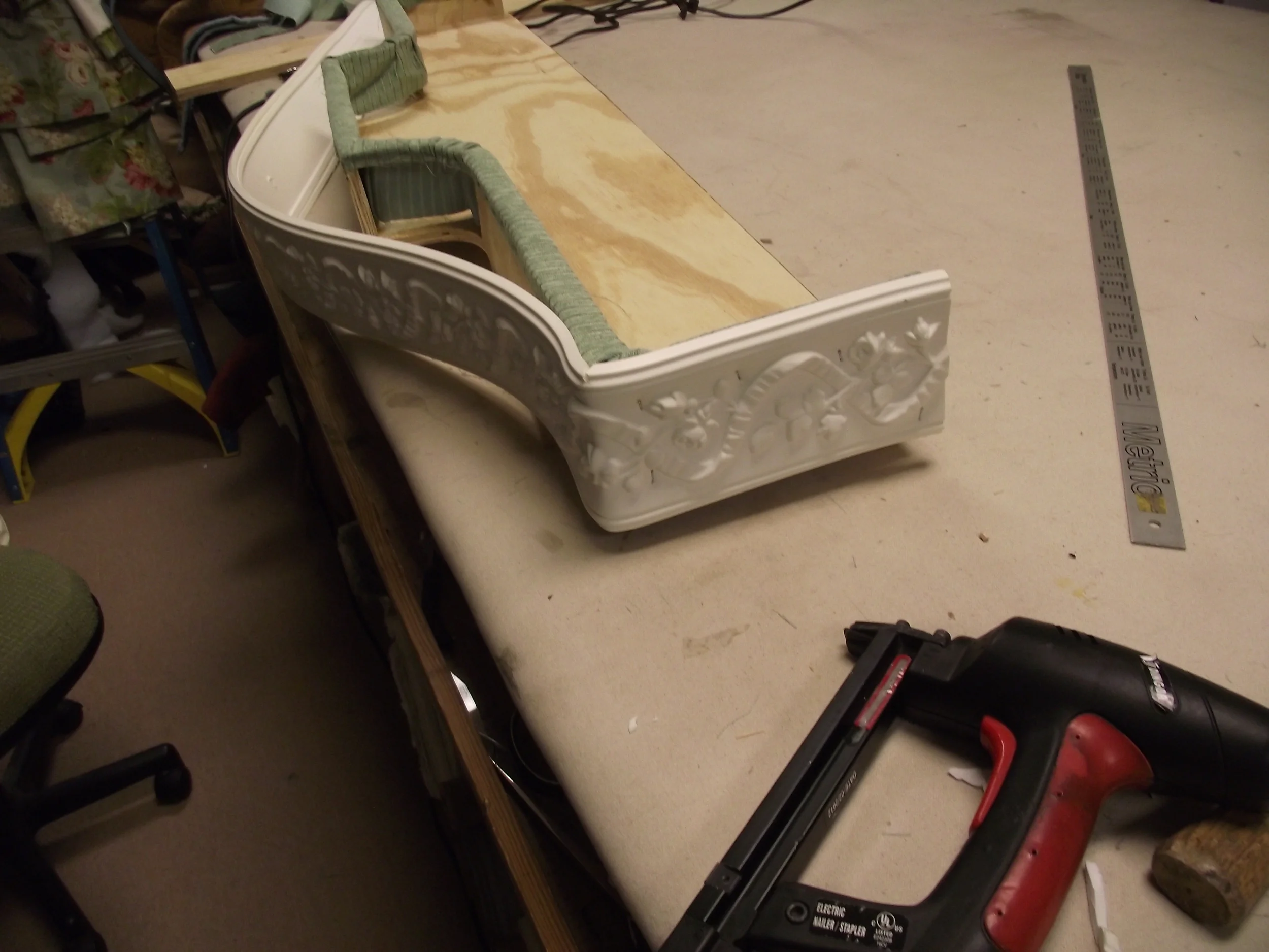 Bendable molding being attached to cornice frame. Notice the 45 degree corner.