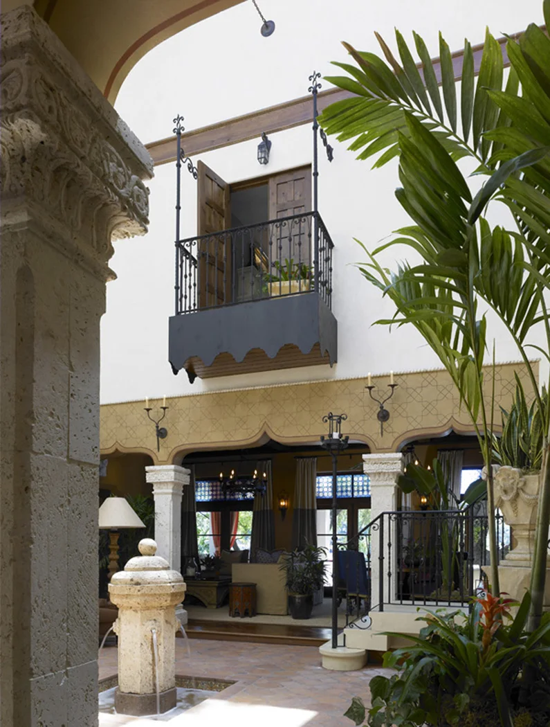 A master suite’s indoor balcony overlooks a atrium and fountain in this Mediterranean home in Winter Park, FL.