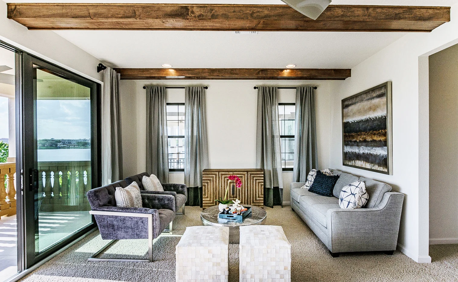 Wood beam details in the sitting room gives this home the perfect amount of architectural detailing. An eclectic mixture of furniture compliments the rooms in the most attractive way.