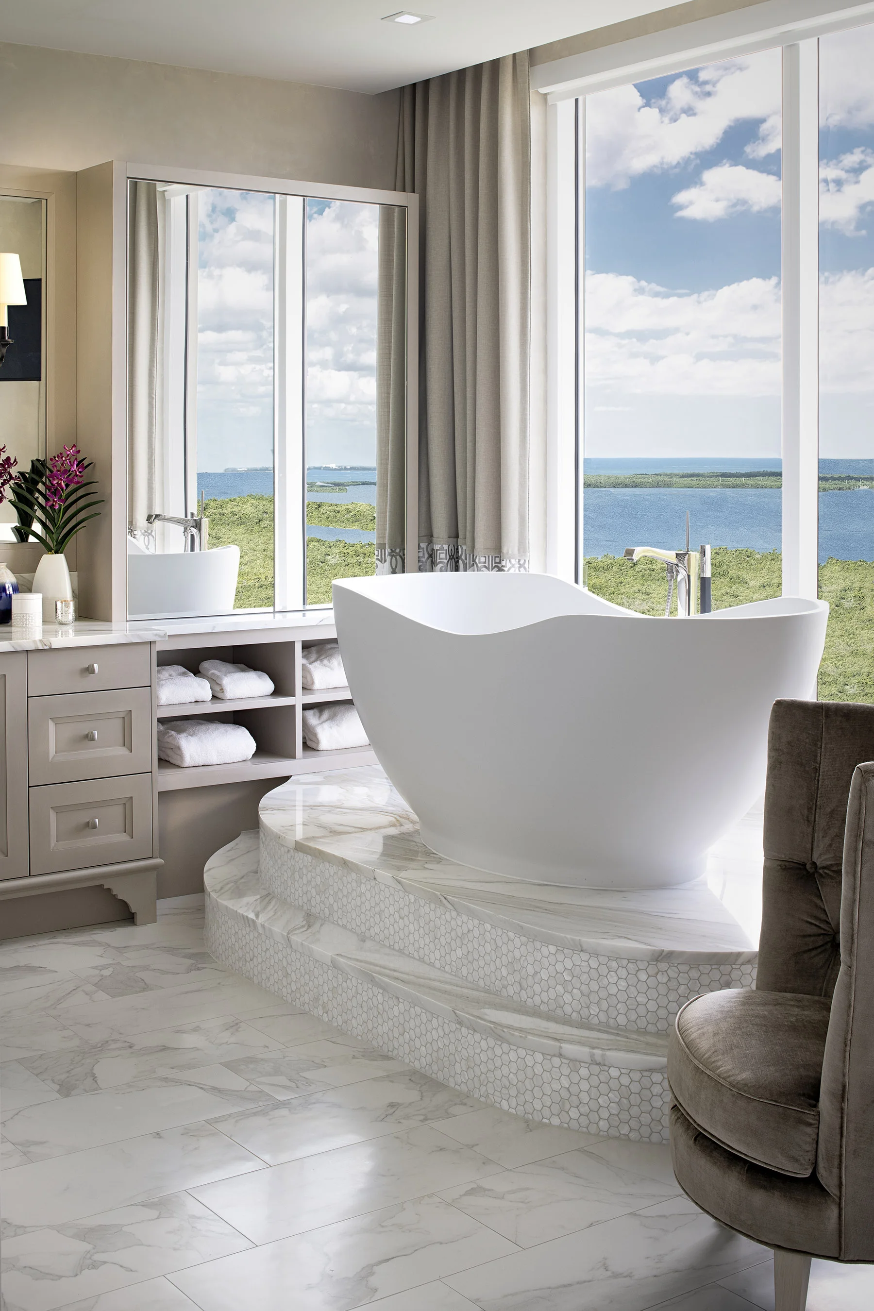 The very calming master bath features a grand stand alone tub held by layers of granite and mosaic tiles.