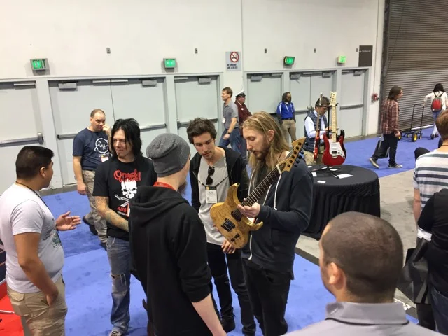 Perry chatting with Keith Merrow, Ola Englund, and Plini.