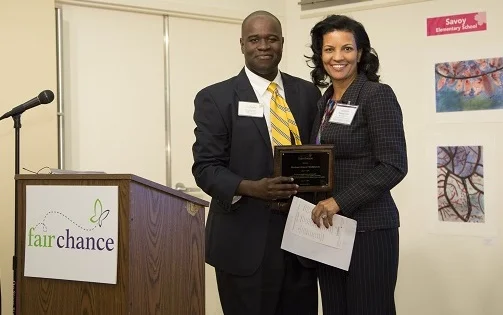 Horizons Greater Washington Board Chair Brenda Jews accepts the plaque from Reggie Grant, Fair Chance Training and Capacity Building Specialist. 