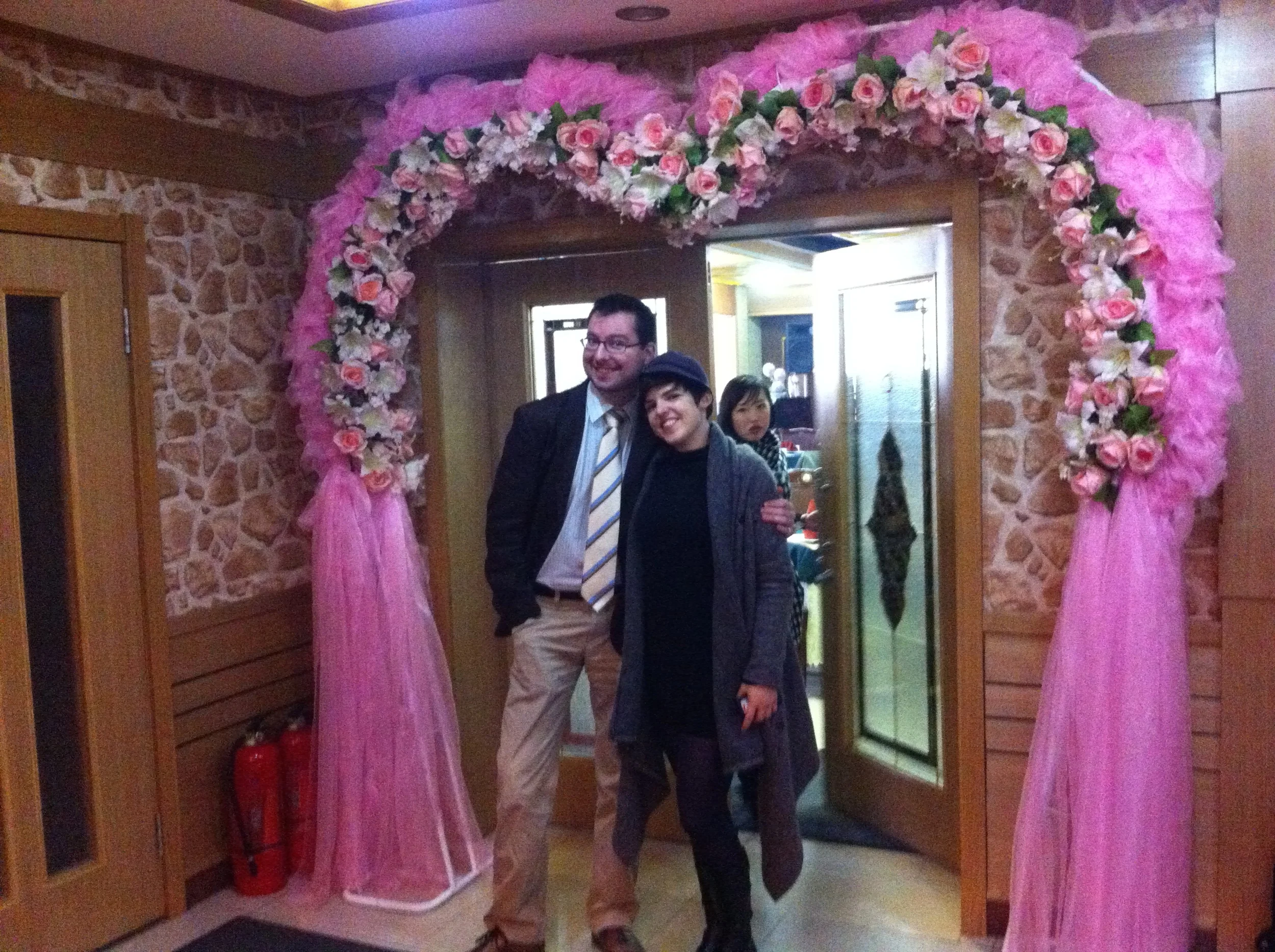 Choson Exchange teammate Nils and a workshop leader in front of a funky restaurant decoration