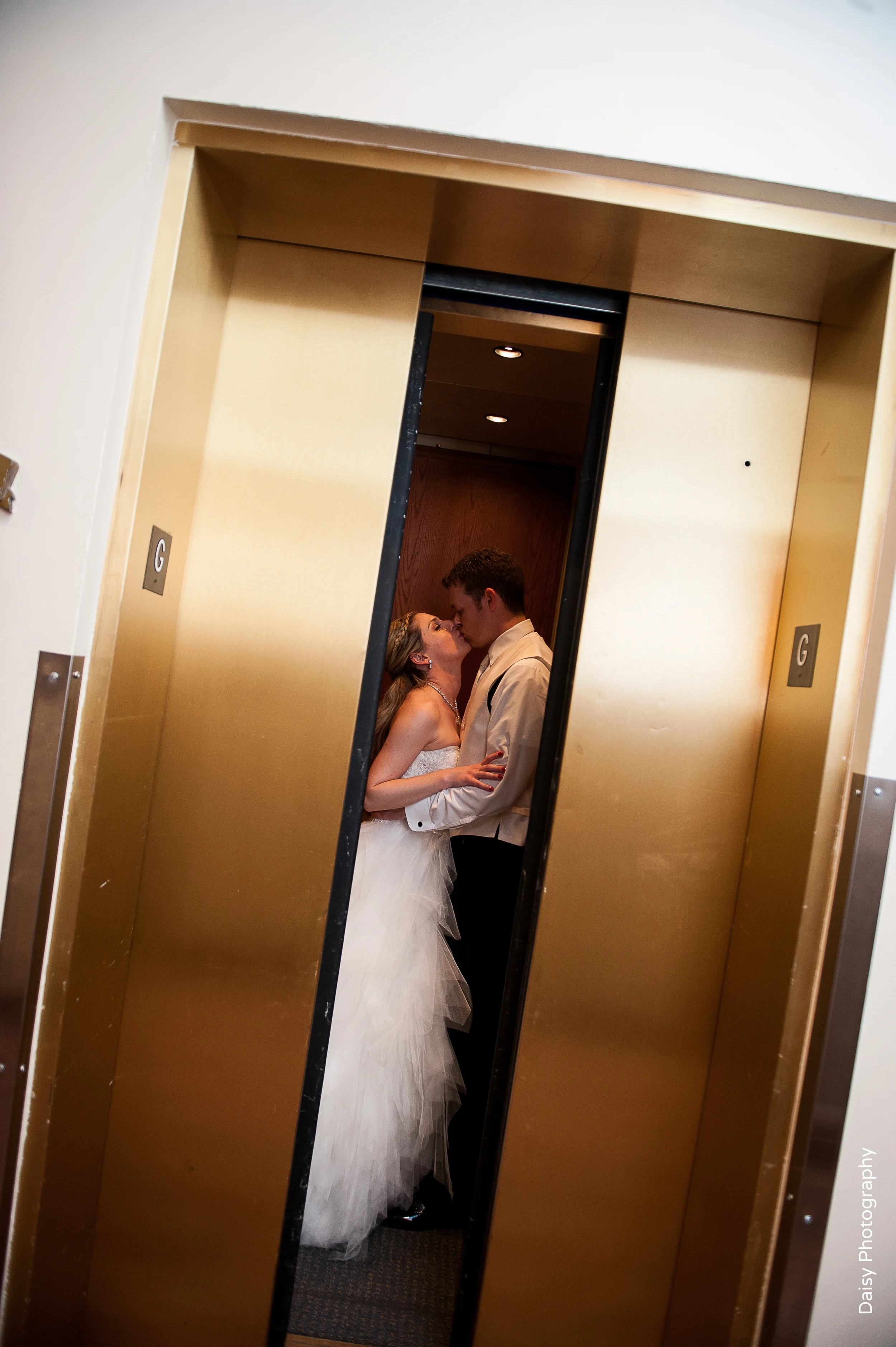 Bride & Groom Kissing in Elevator